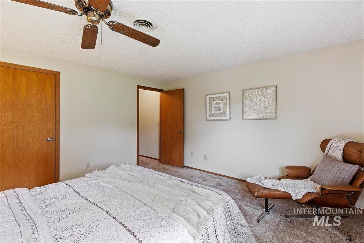 Interior room featuring a ceiling fan, carpet flooring, and white walls