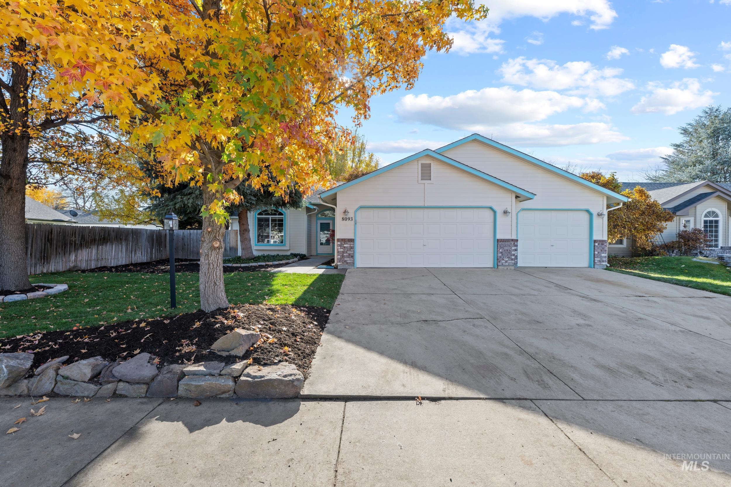 Ranch-style house featuring driveway, a garage, and brick siding