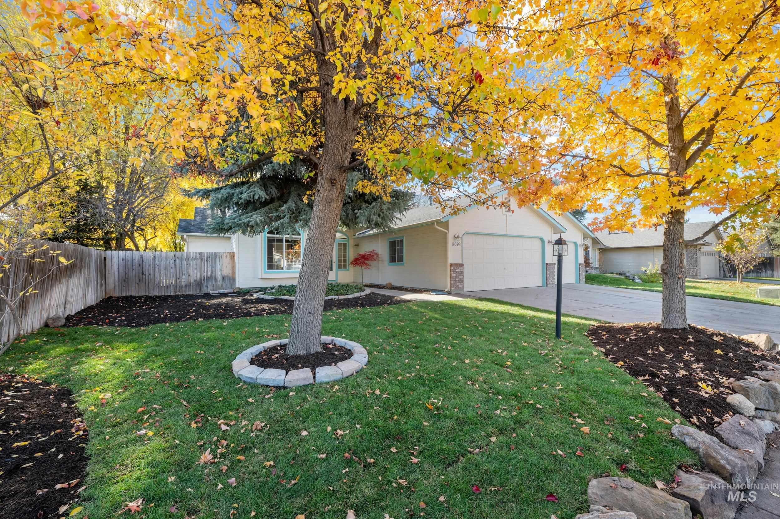 View of front of property with concrete driveway, an attached garage, and brick siding