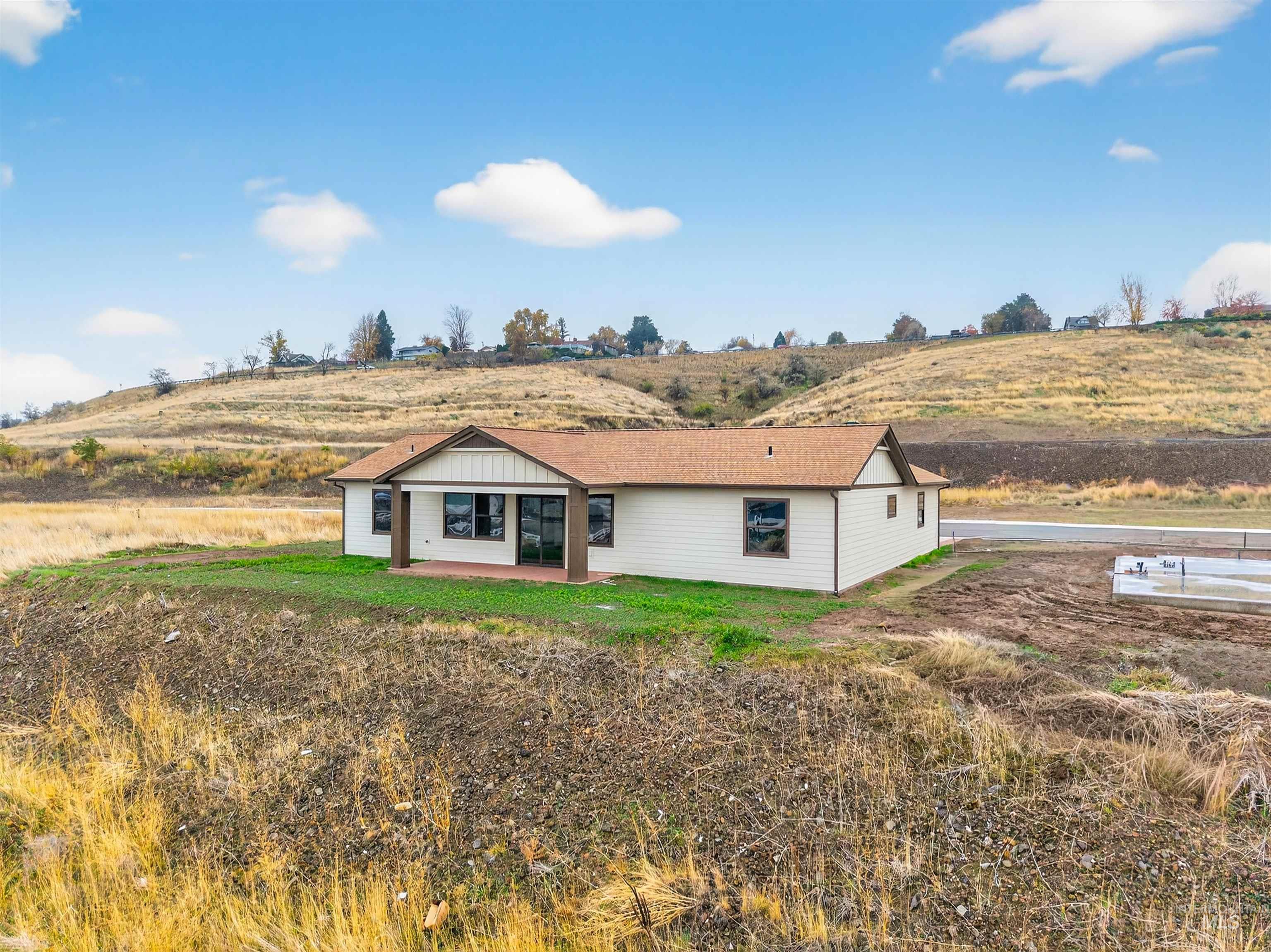 View of front facade featuring a patio and a view of countryside
