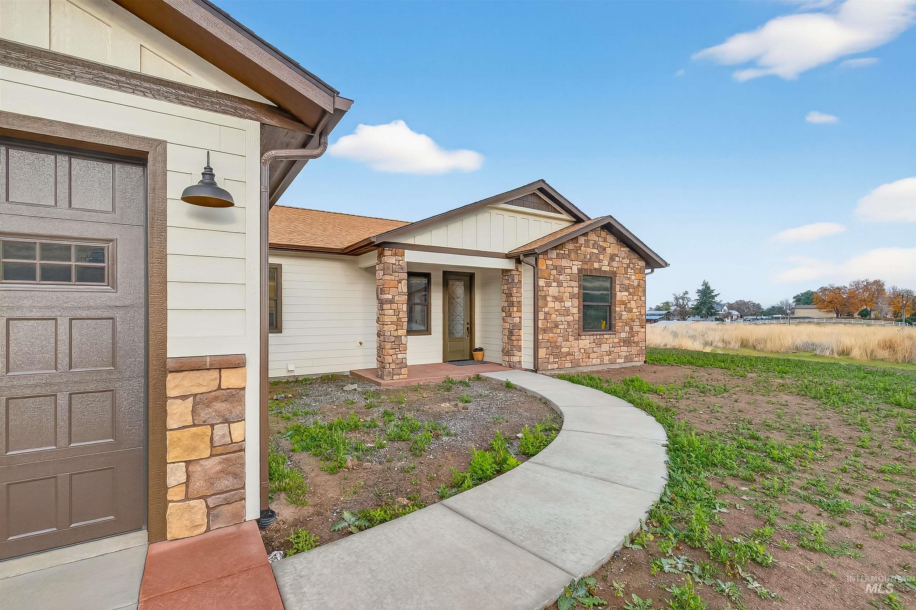 View of exterior entry featuring stone siding and board and batten siding