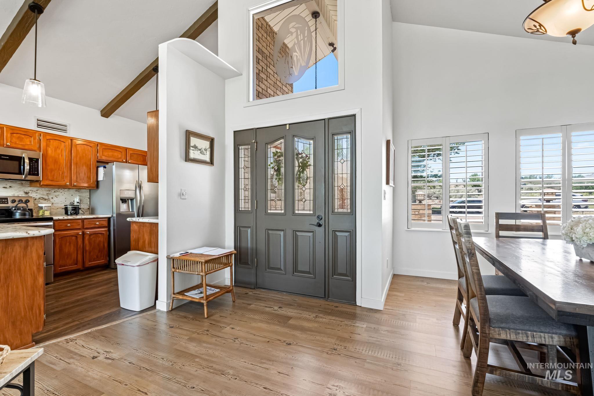 Foyer featuring a towering ceiling and light wood-style floors