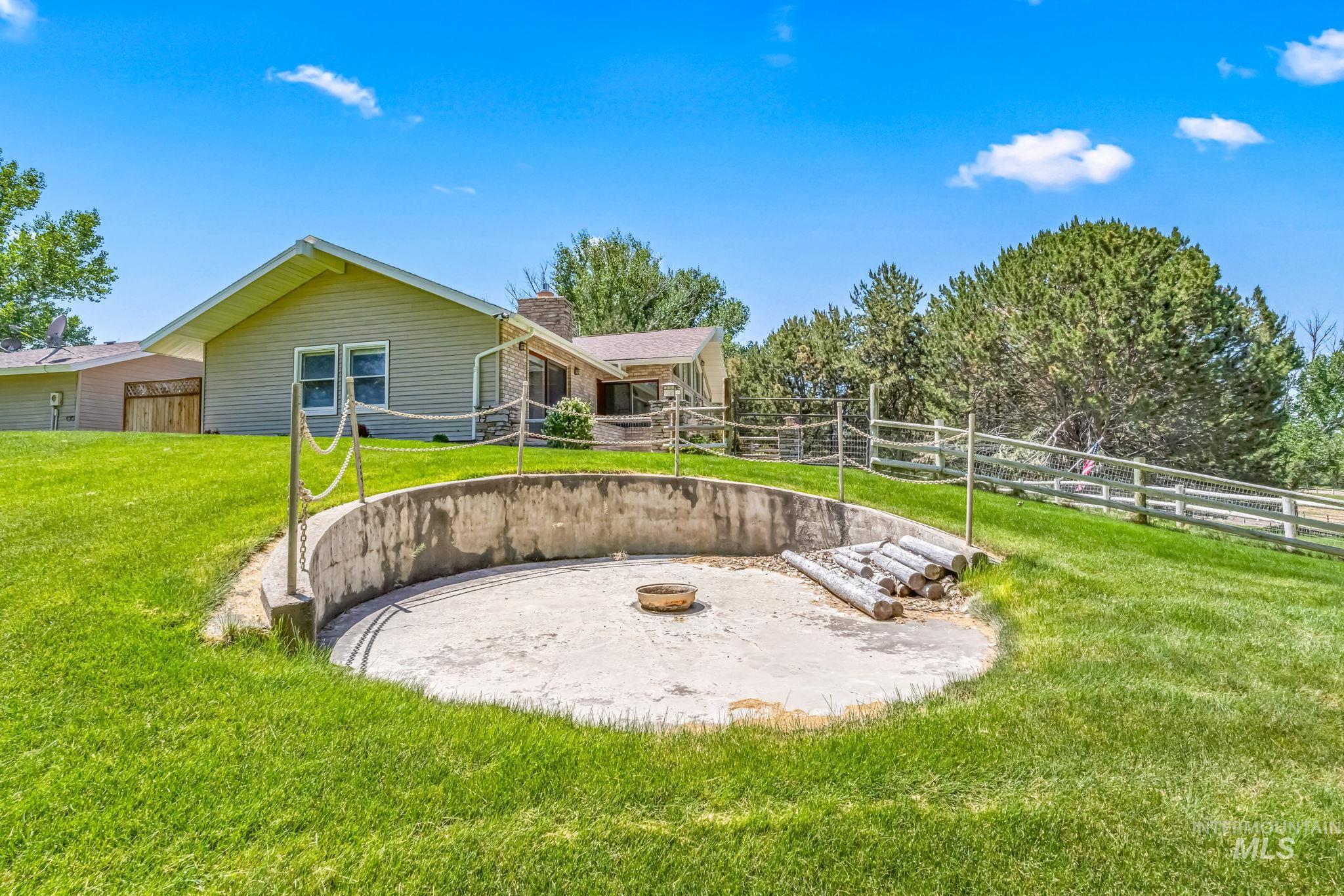 View of yard featuring volleyball court and an outdoor fire pit