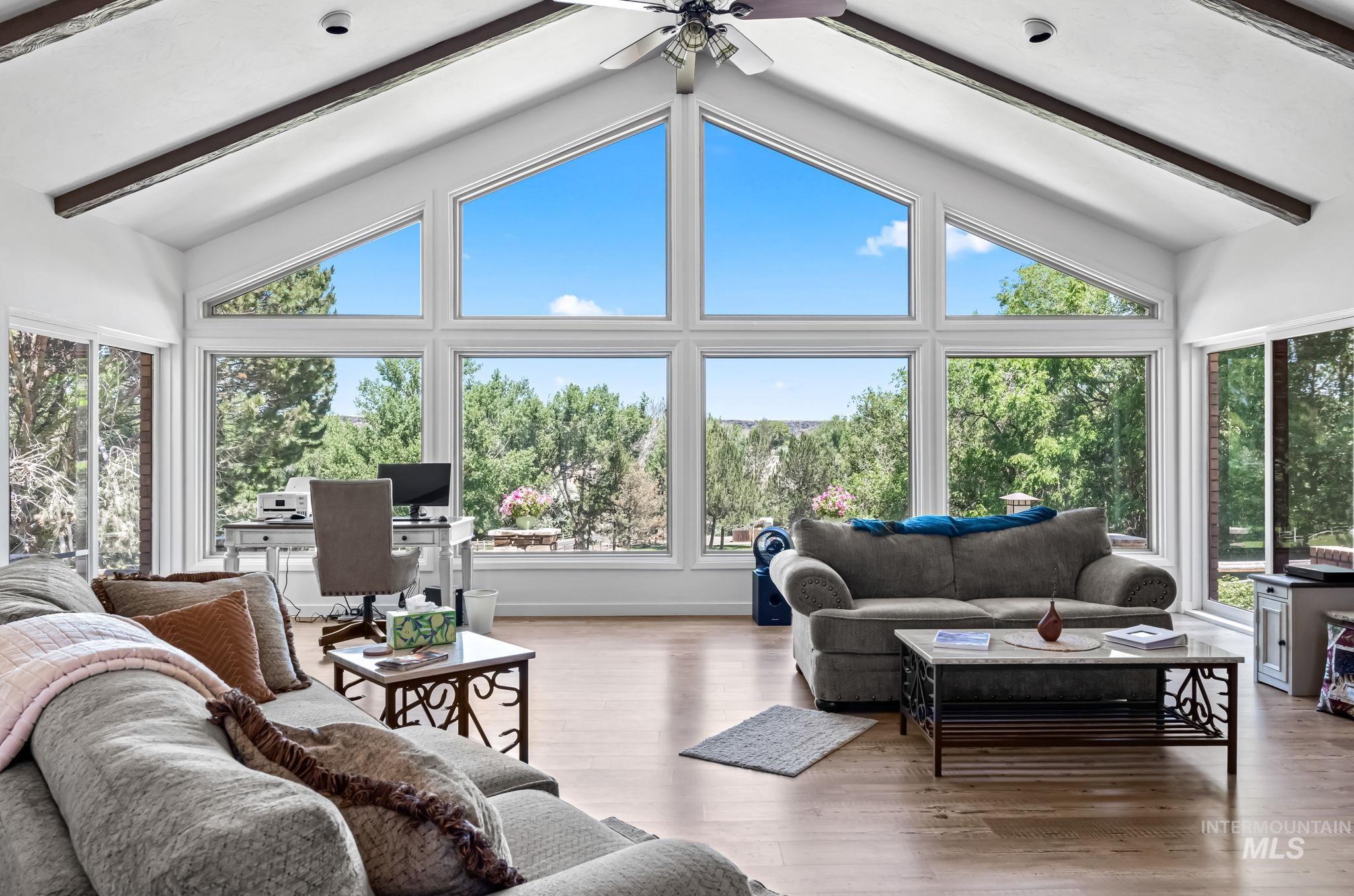 Living area with ceiling fan, wood finished floors, and an office area