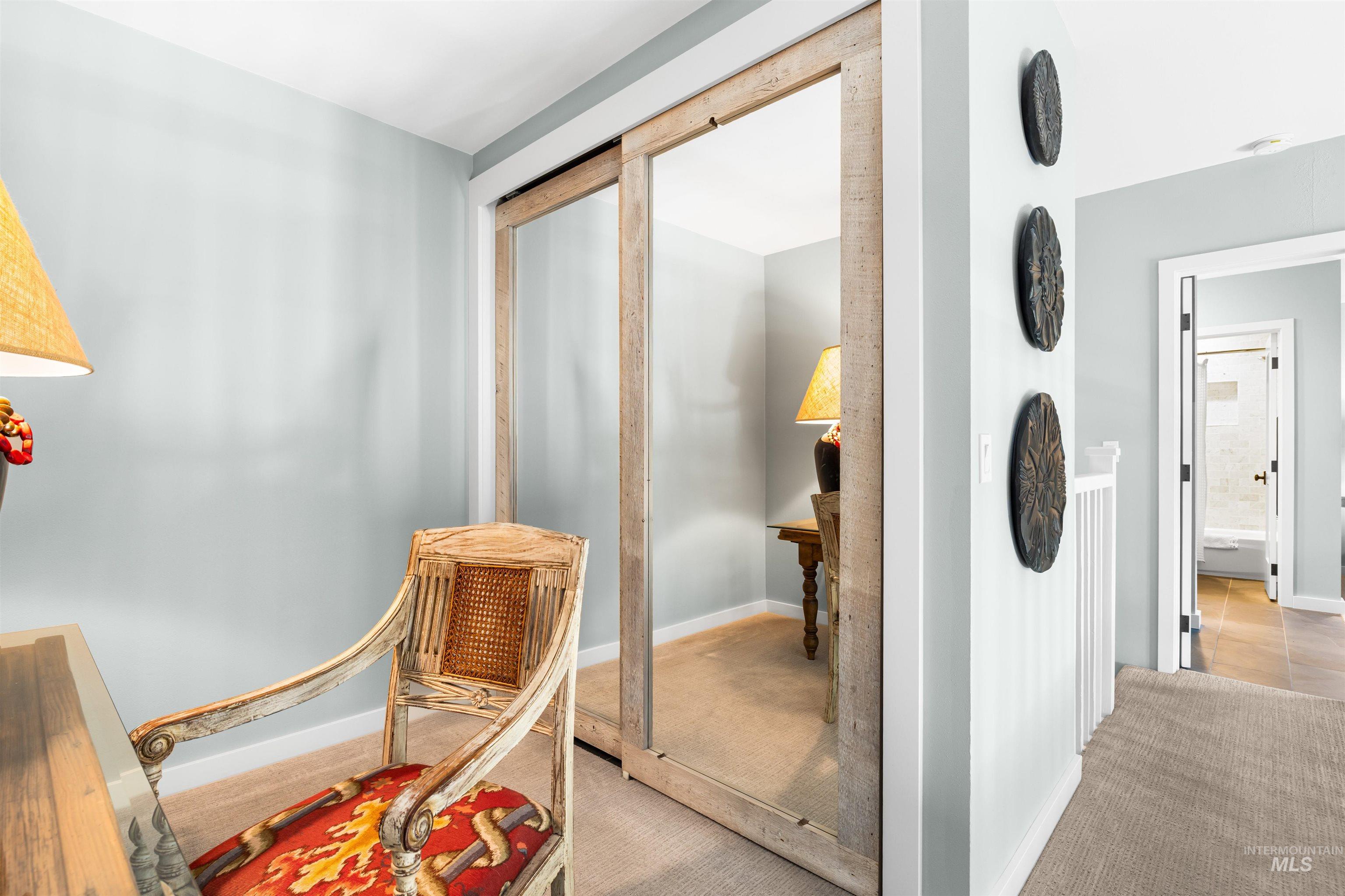 Hall featuring carpet and baseboards