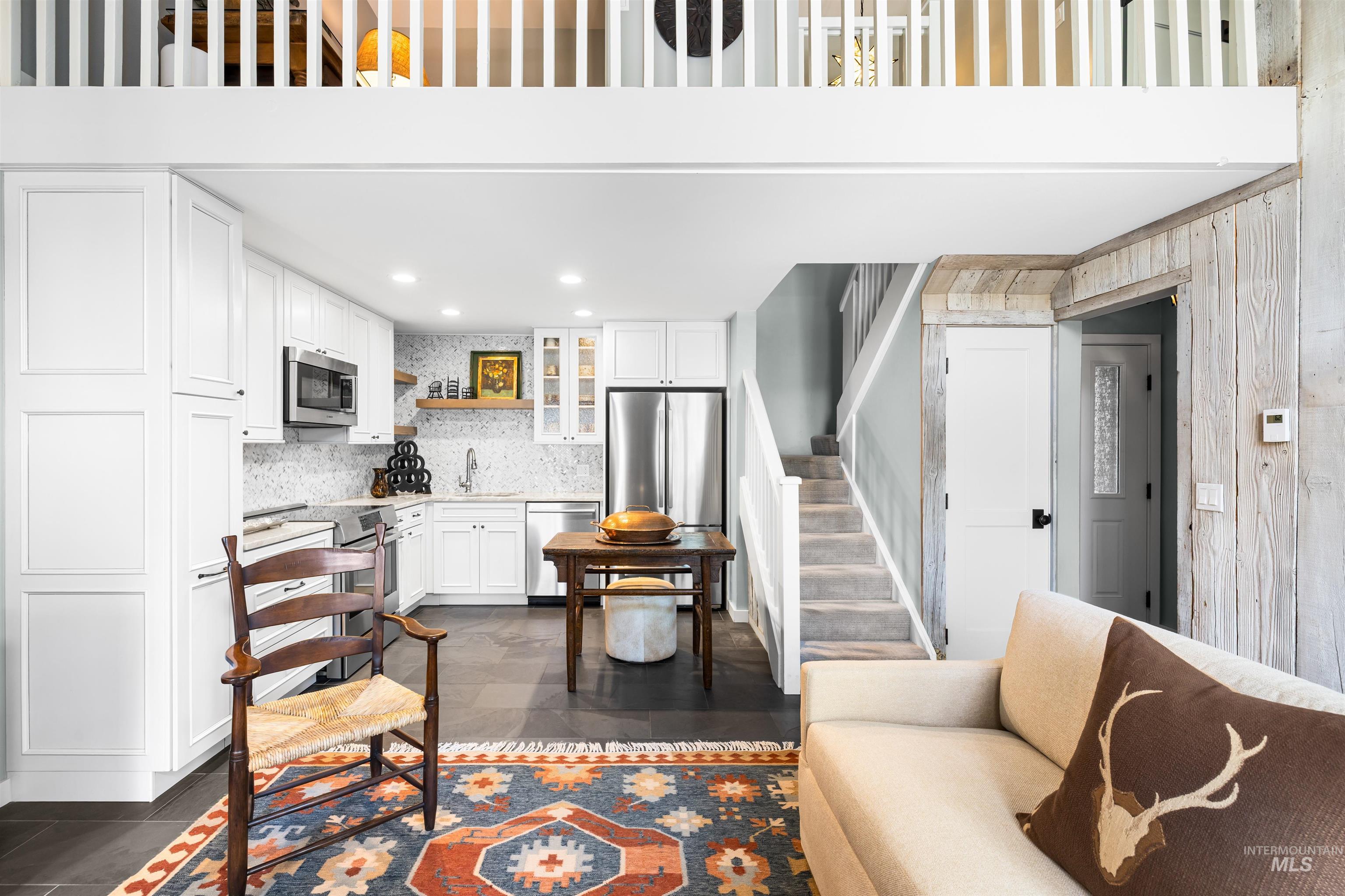 Living room with stairs and recessed lighting