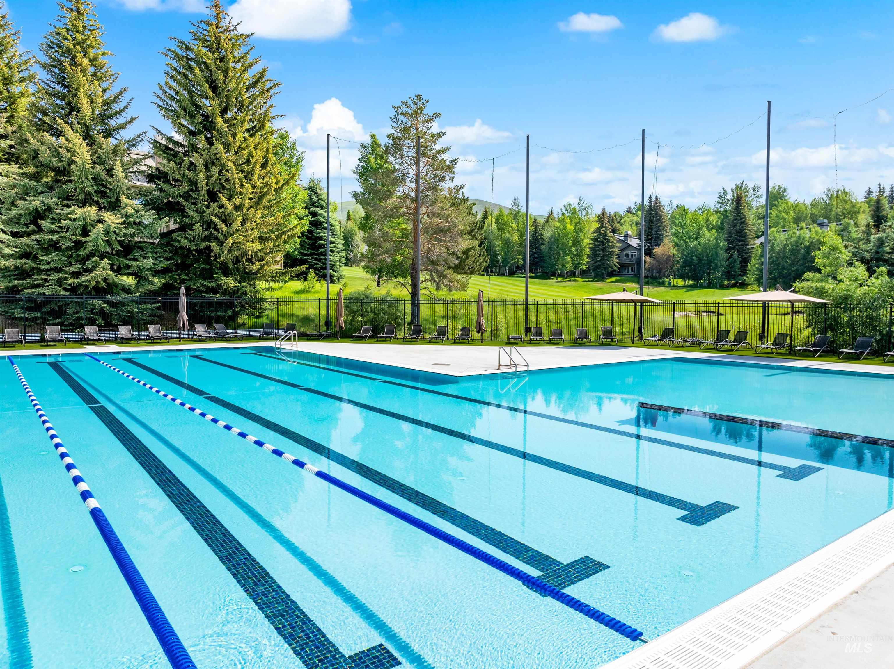 Community pool with view of wooded area