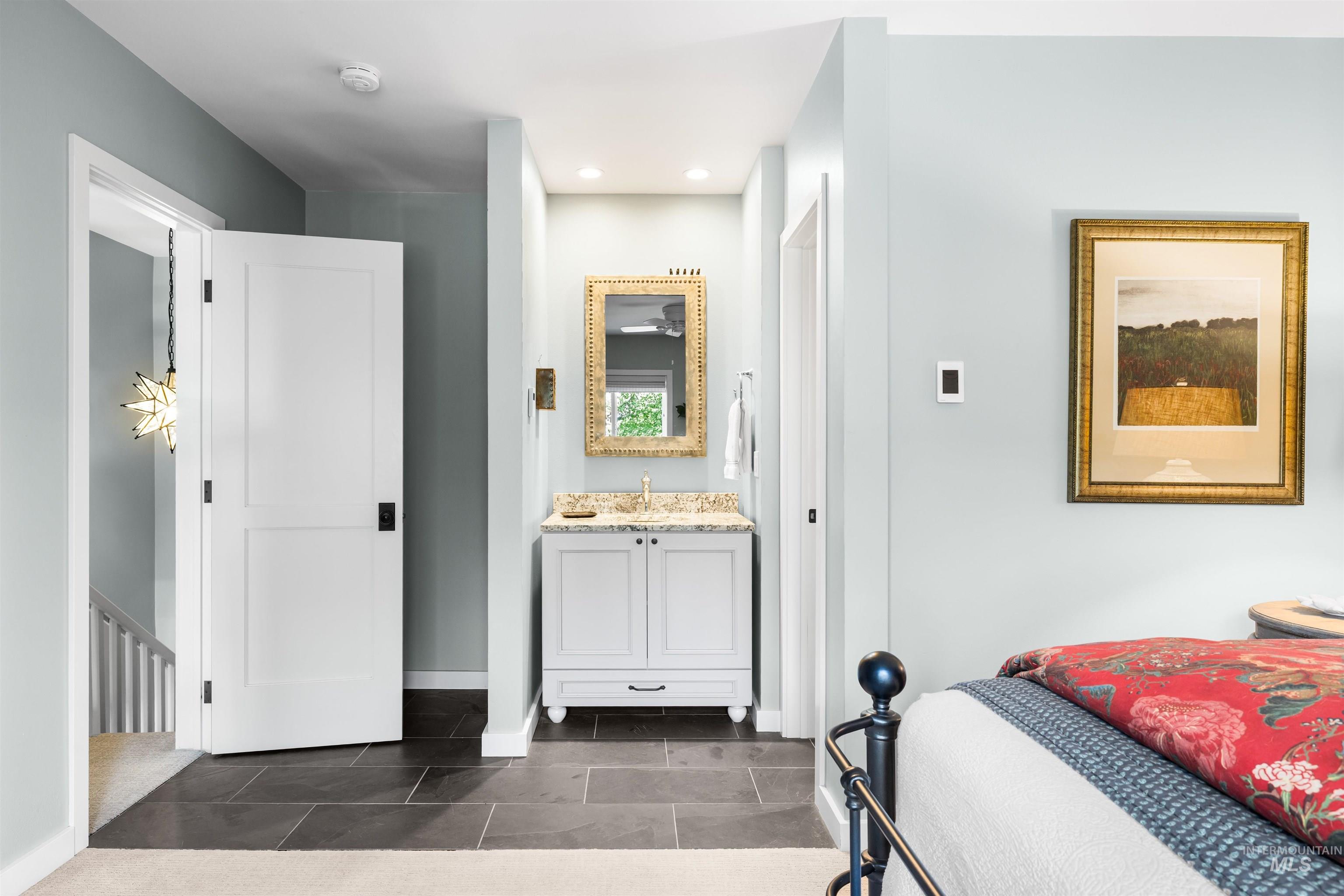 Bathroom featuring vanity, recessed lighting, and tile patterned flooring