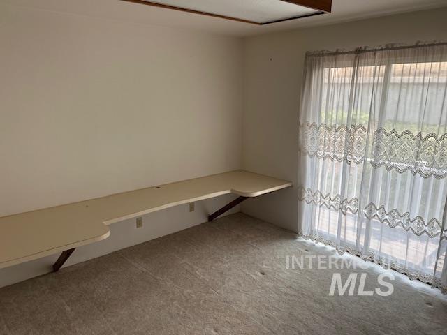 Unfurnished office featuring carpet flooring
