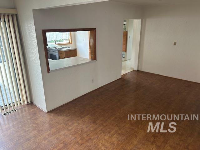 Empty room with dark wood finished floors