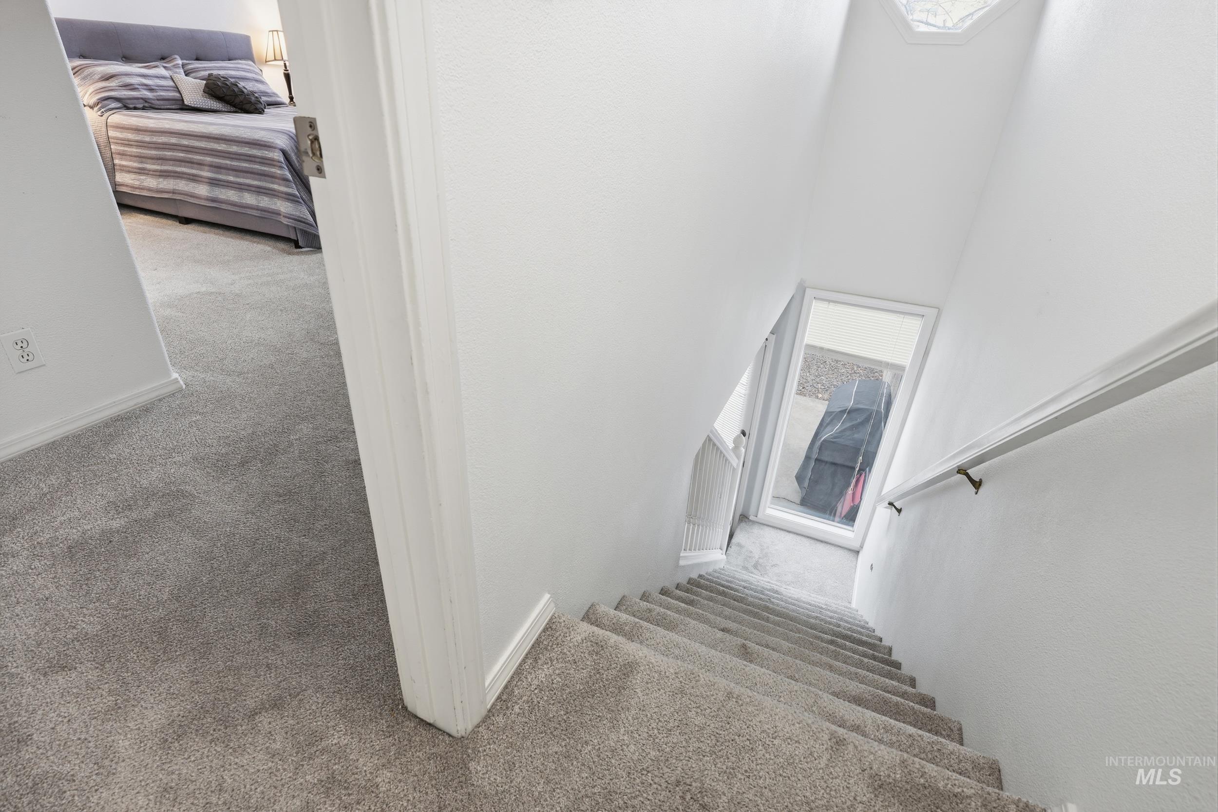 Staircase featuring carpet floors and a towering ceiling