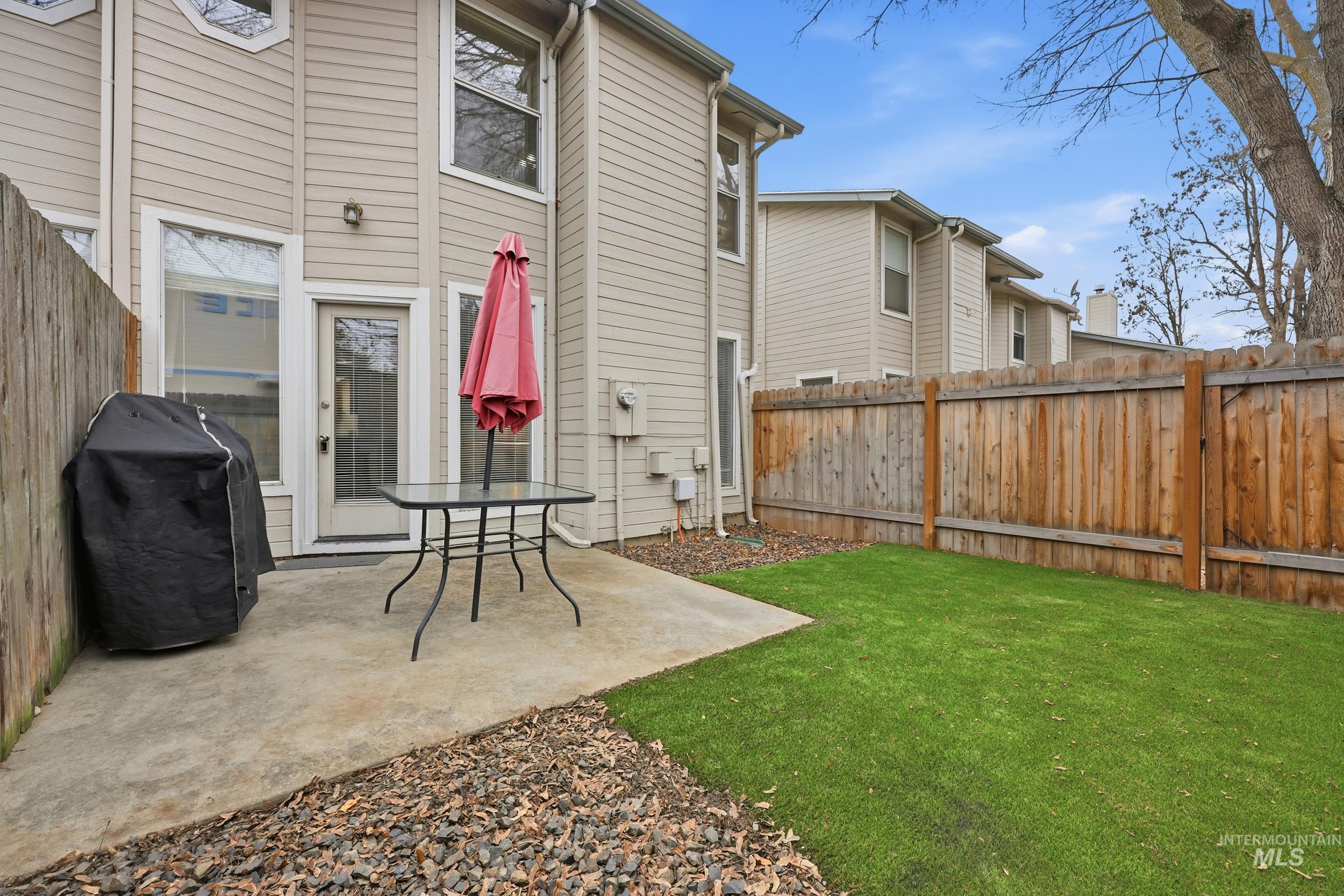 Fenced backyard with a patio