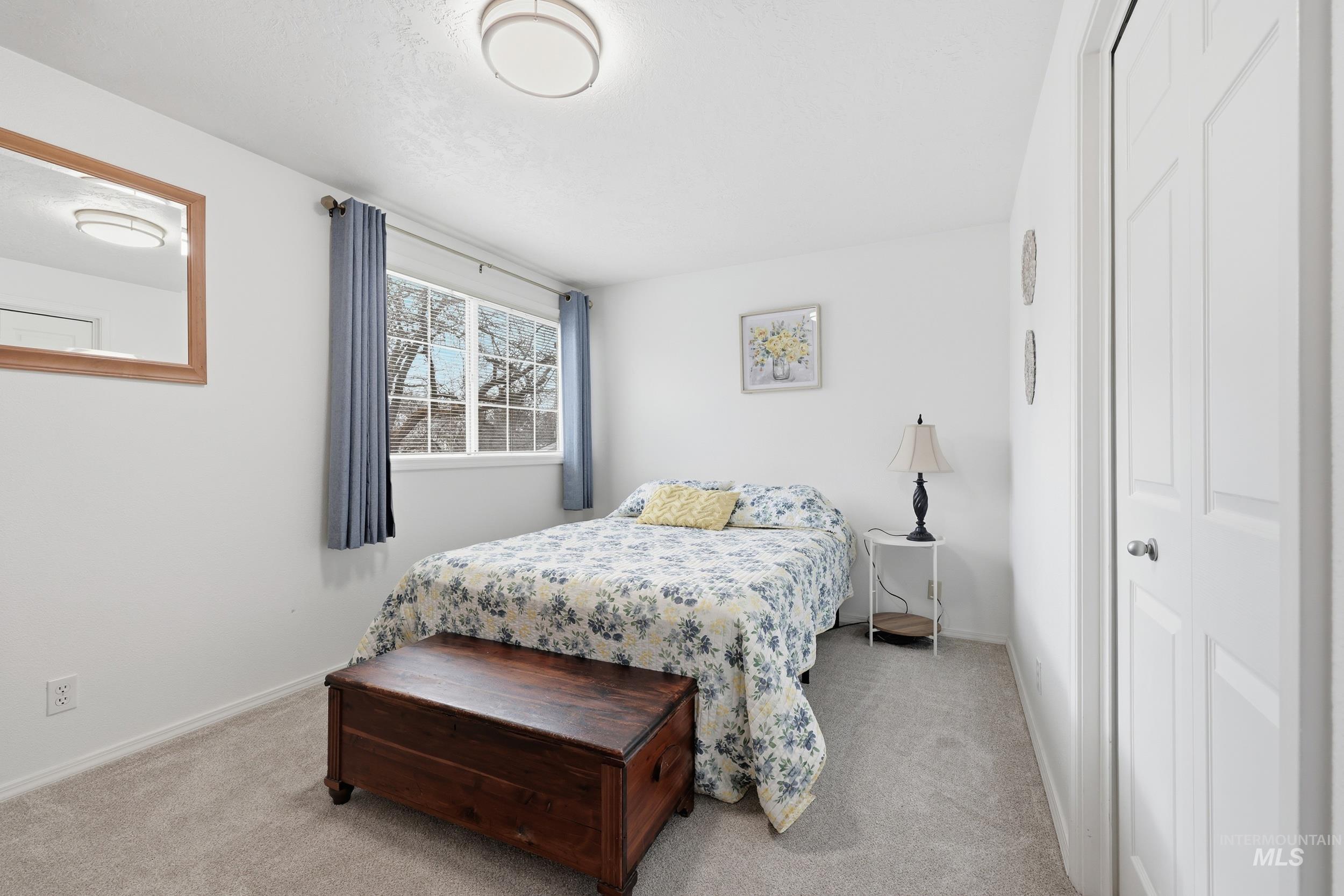 Bedroom featuring light colored carpet and a closet