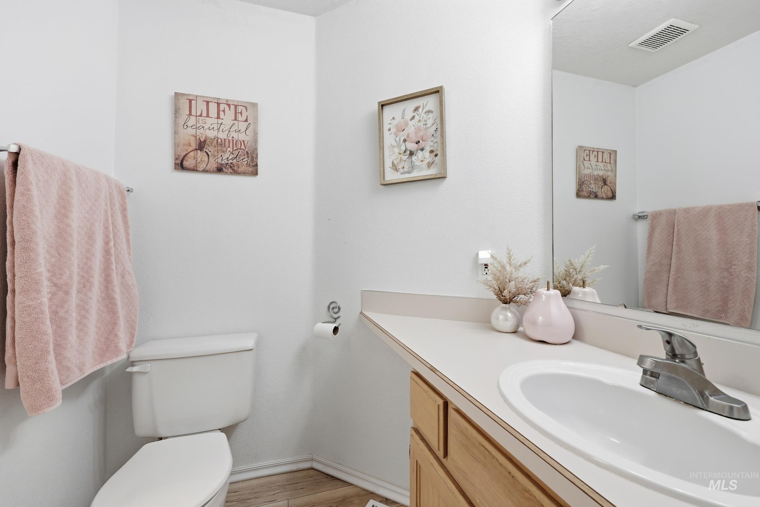 Bathroom featuring vanity and light wood finished floors