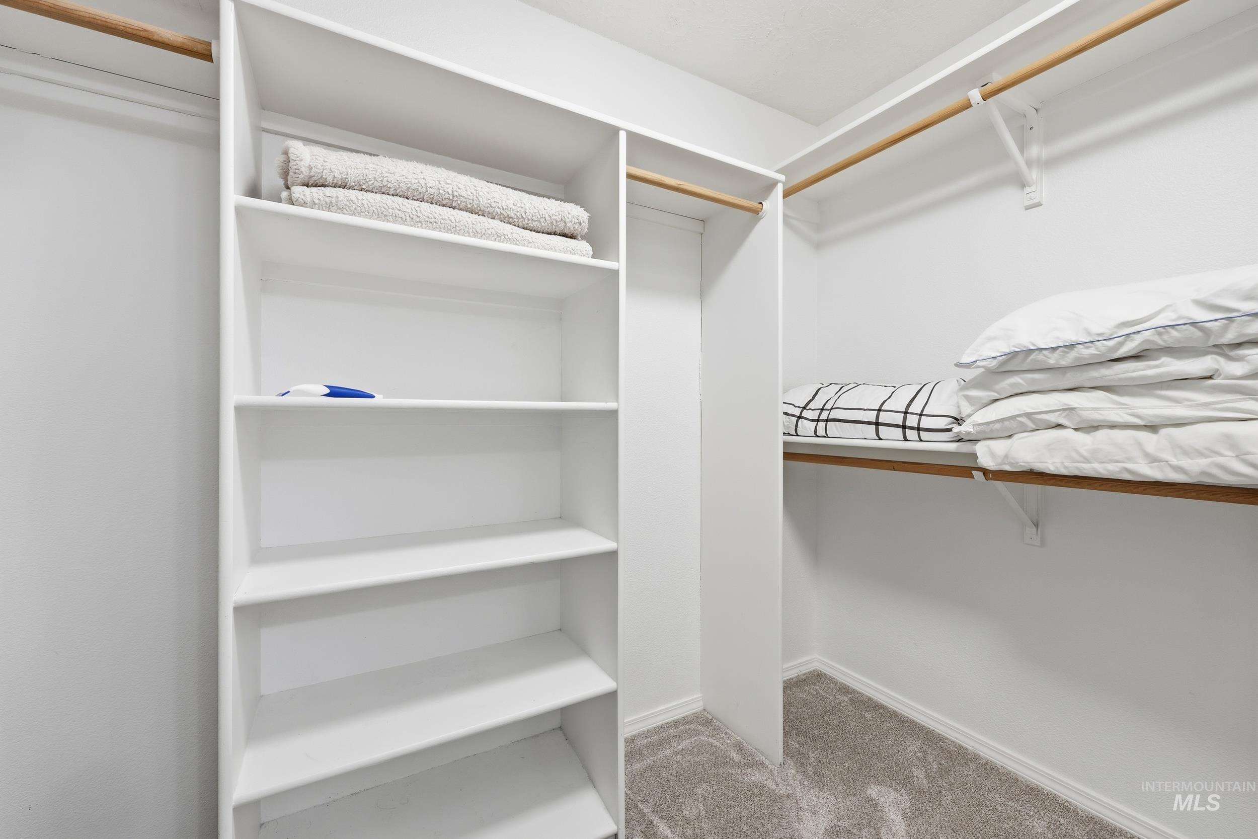 Walk in closet featuring light carpet