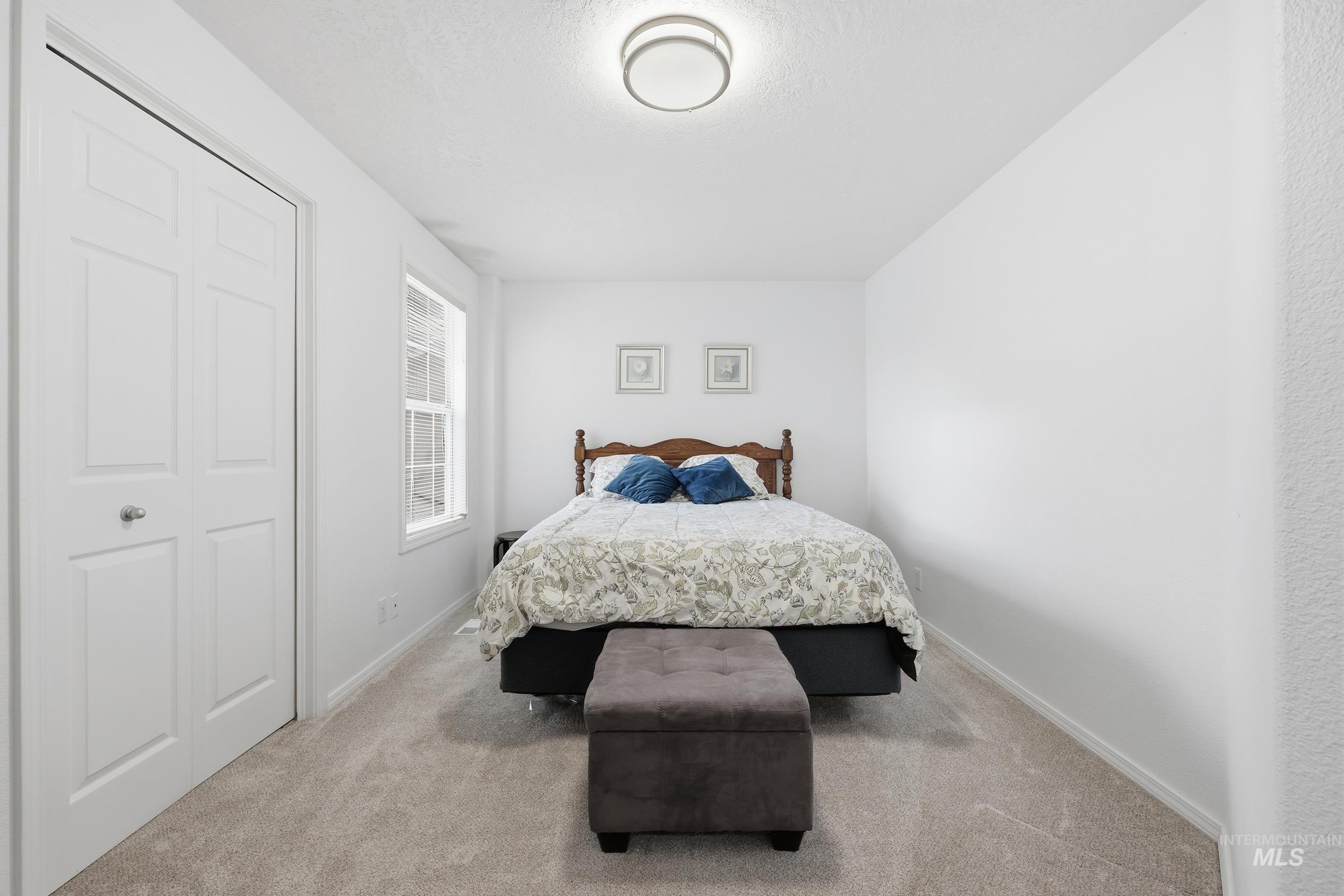 Bedroom featuring carpet flooring and a closet