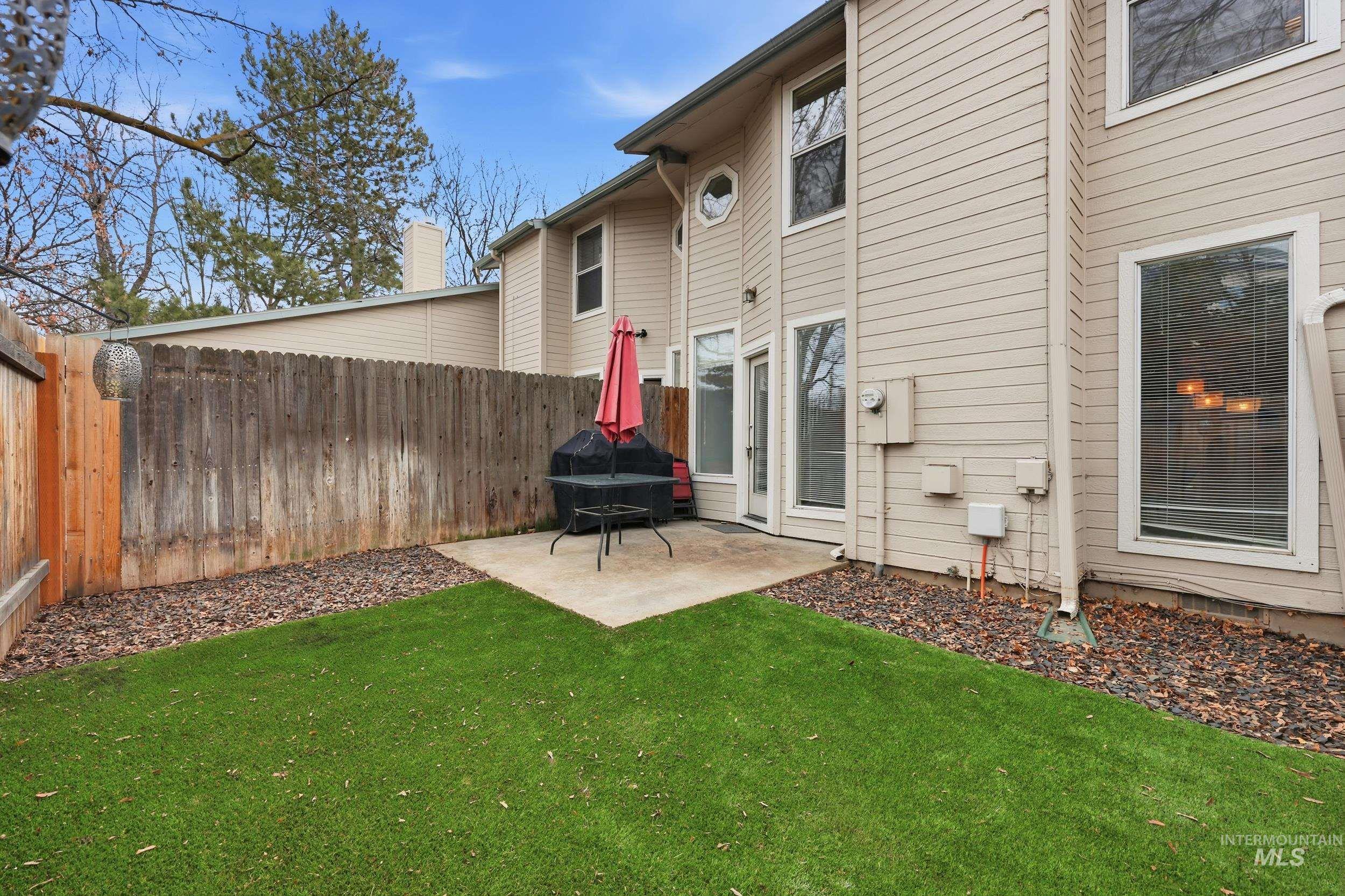 Rear view of property with a patio area, a fenced backyard, and a chimney