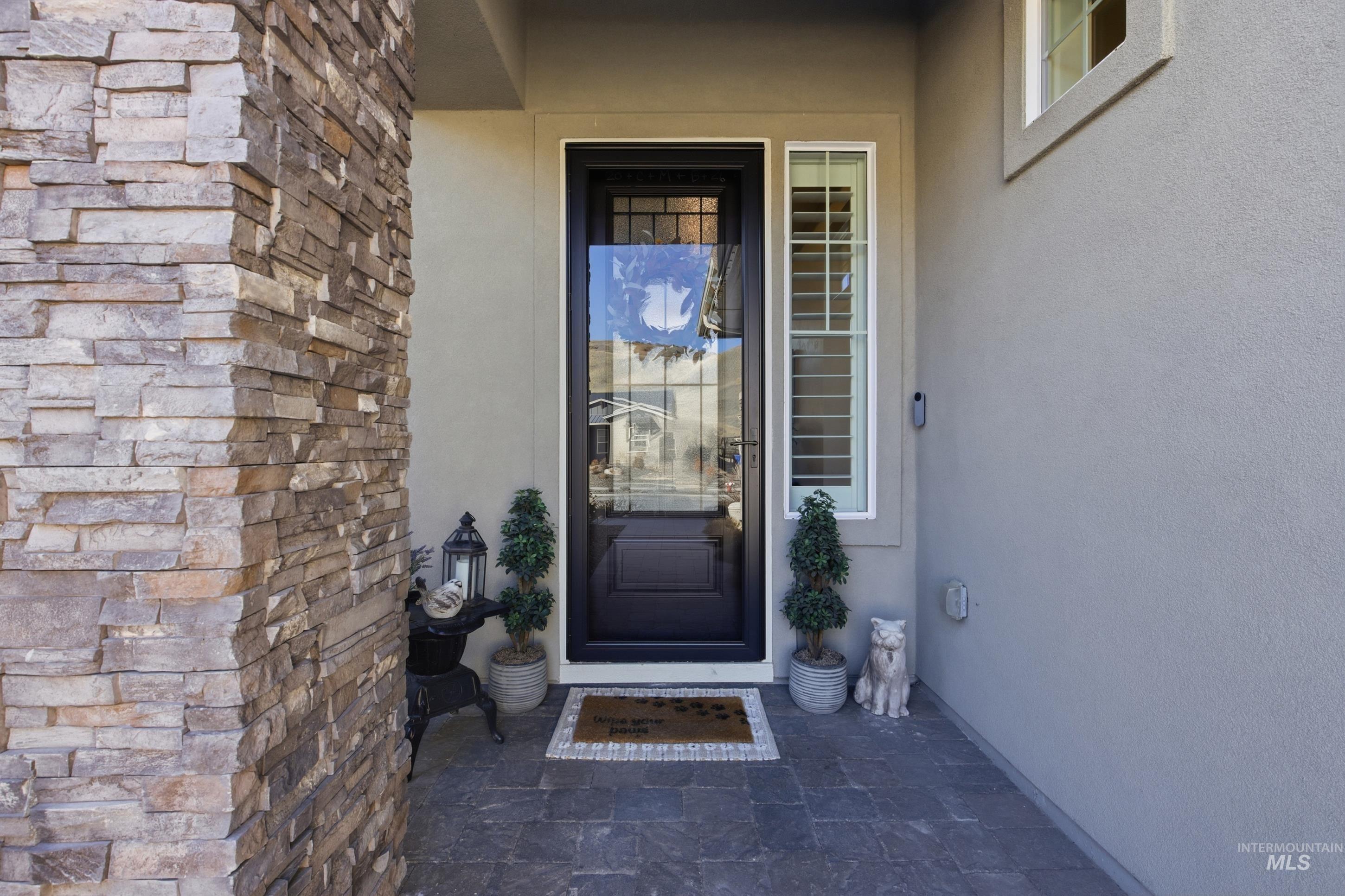 View of exterior entry featuring stucco siding