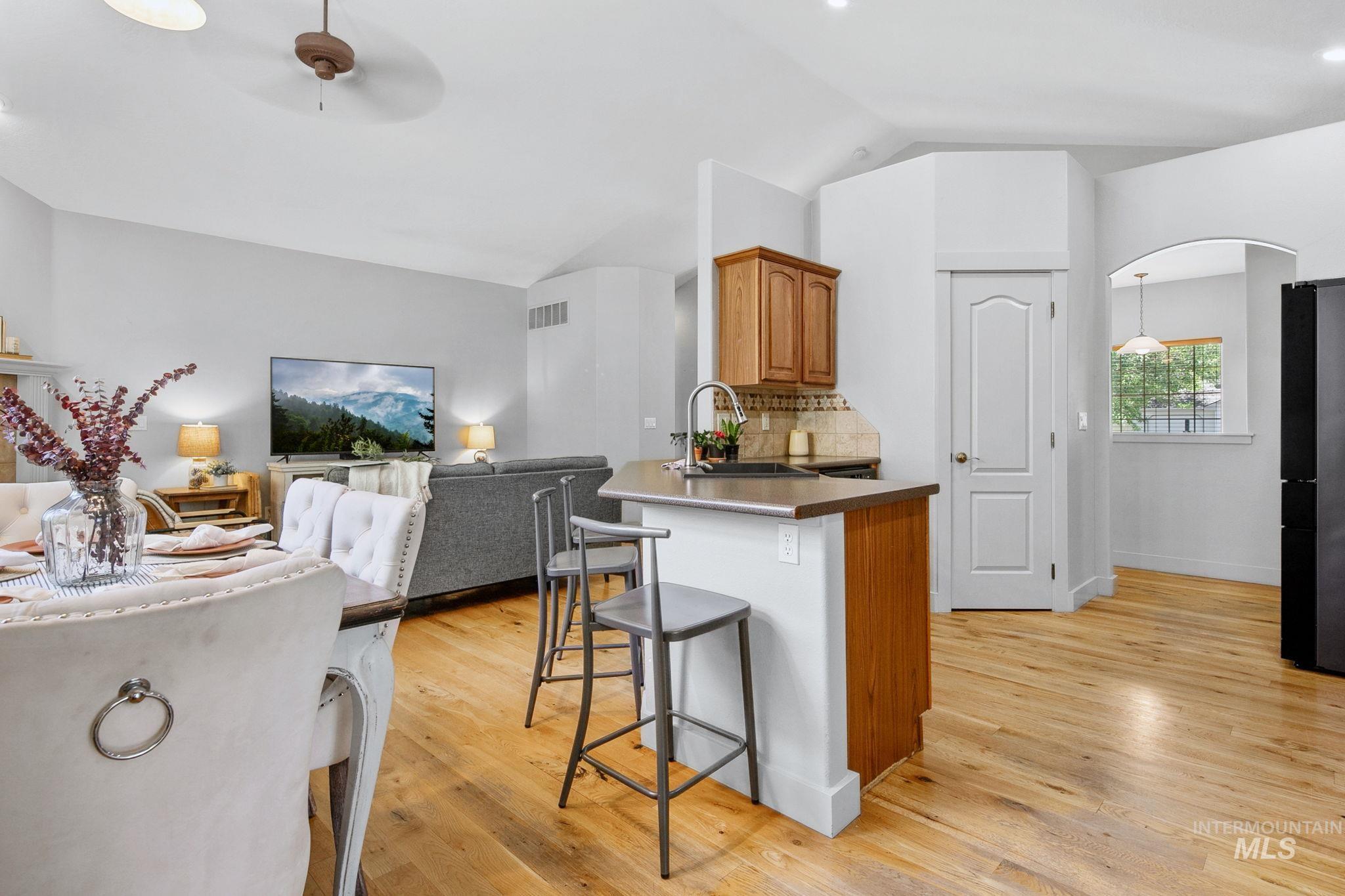 Open-concept living area with wood-finish flooring throughout
