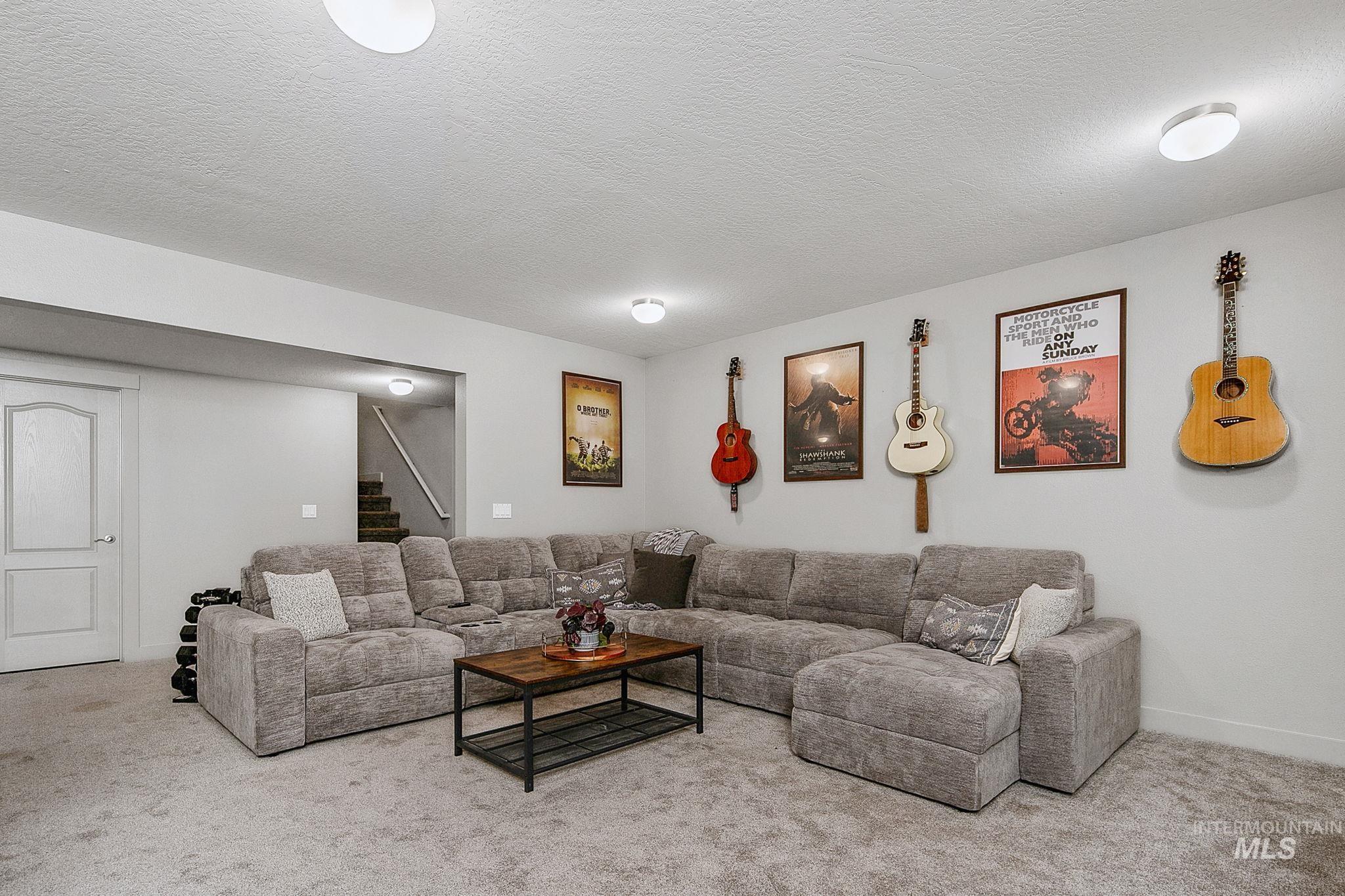 Spacious carpeted room featuring recessed lighting and a white paneled door