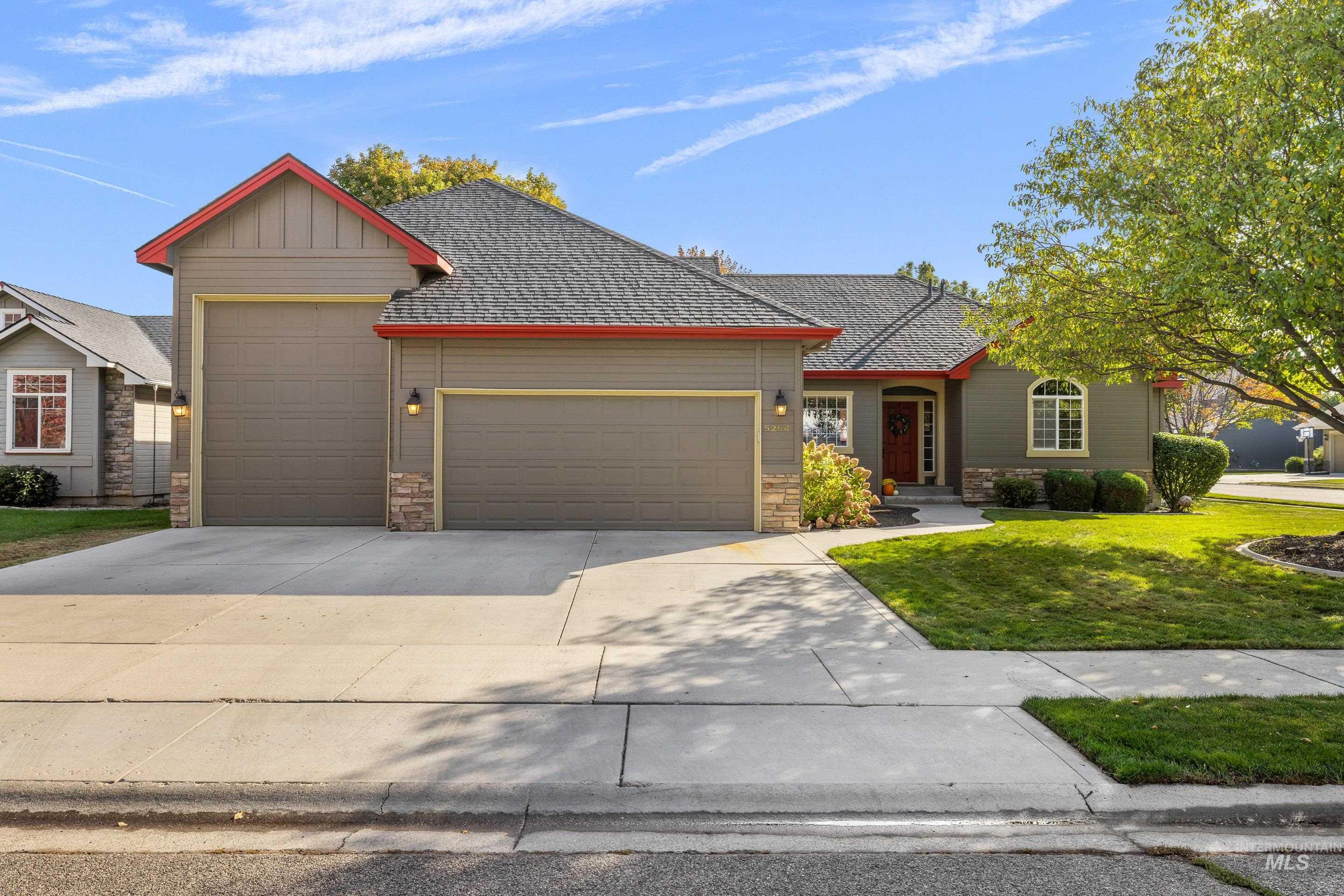 Single-story residence featuring a two-car garage and an additional one-car garage