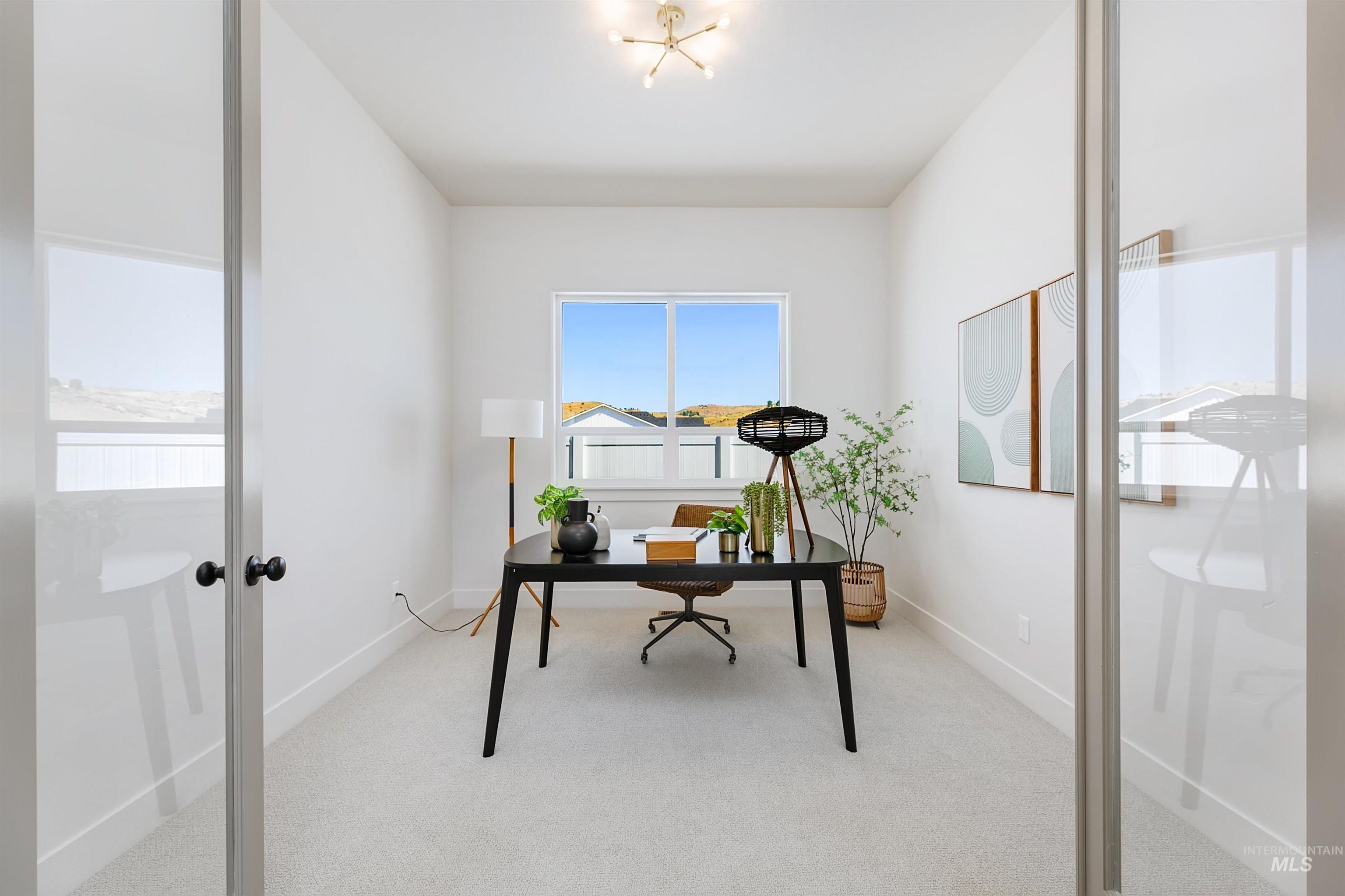Carpeted office with baseboards and french doors