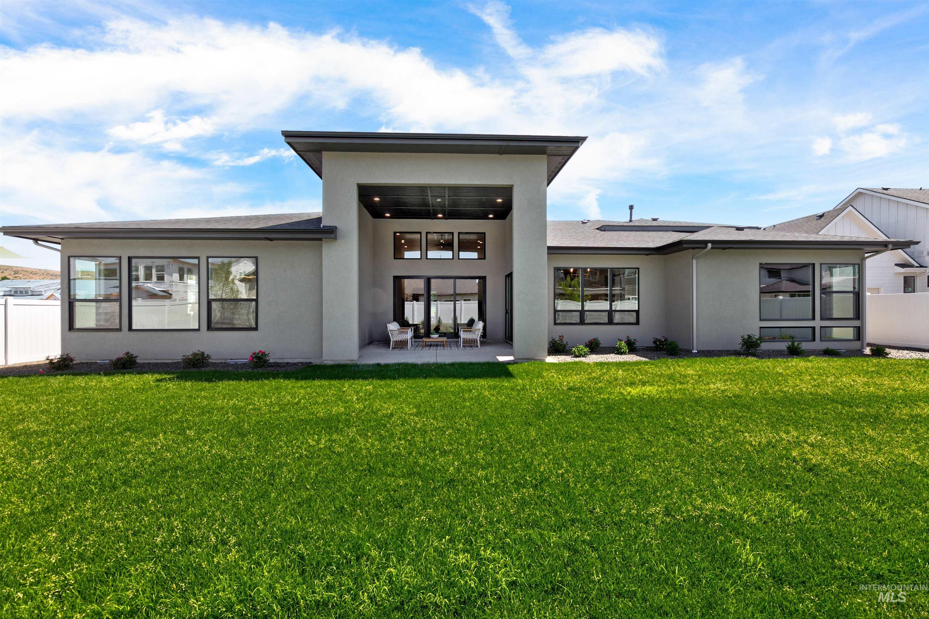 Rear view of property with a patio and stucco siding