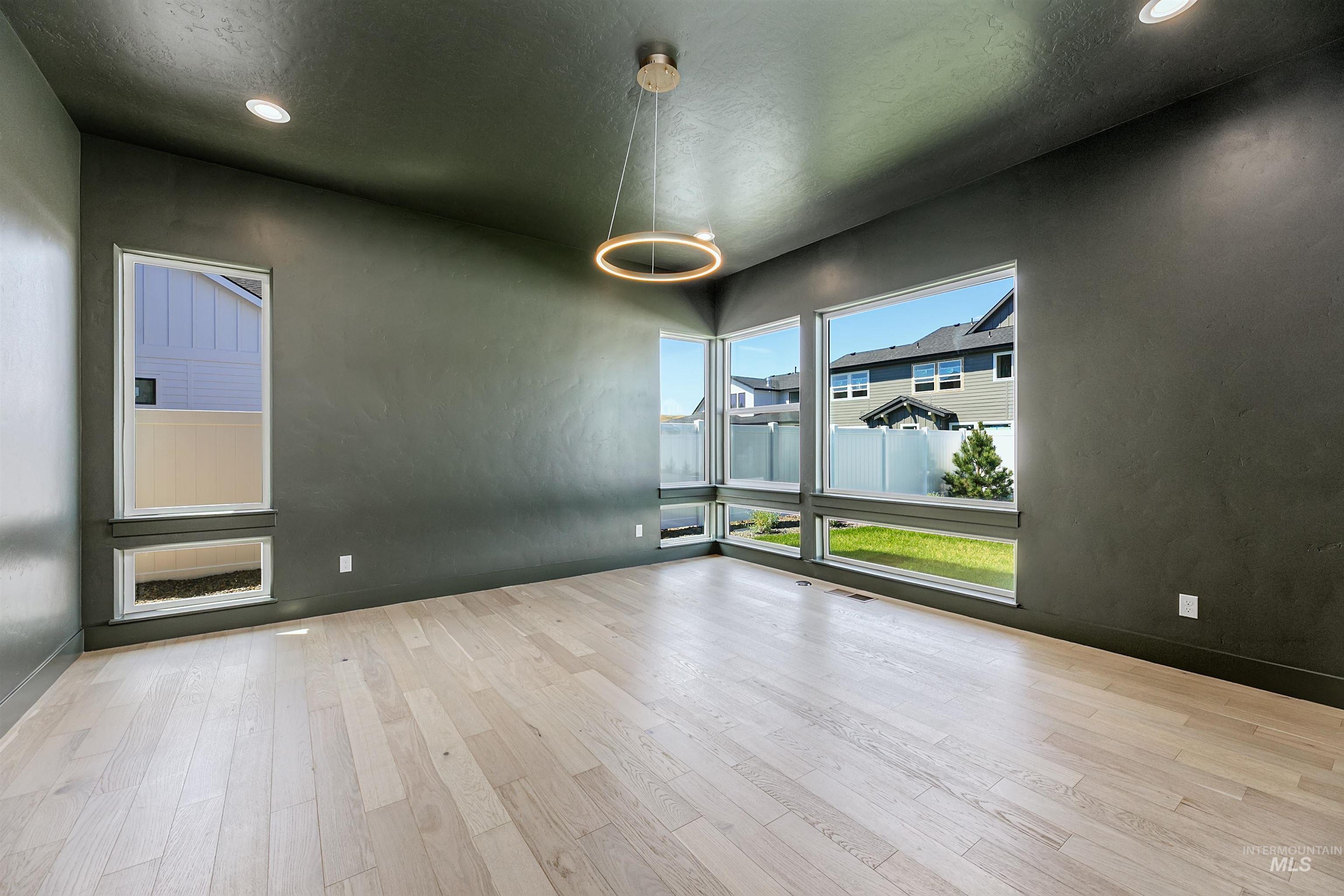 Spare room featuring wood finished floors, recessed lighting, and a textured ceiling