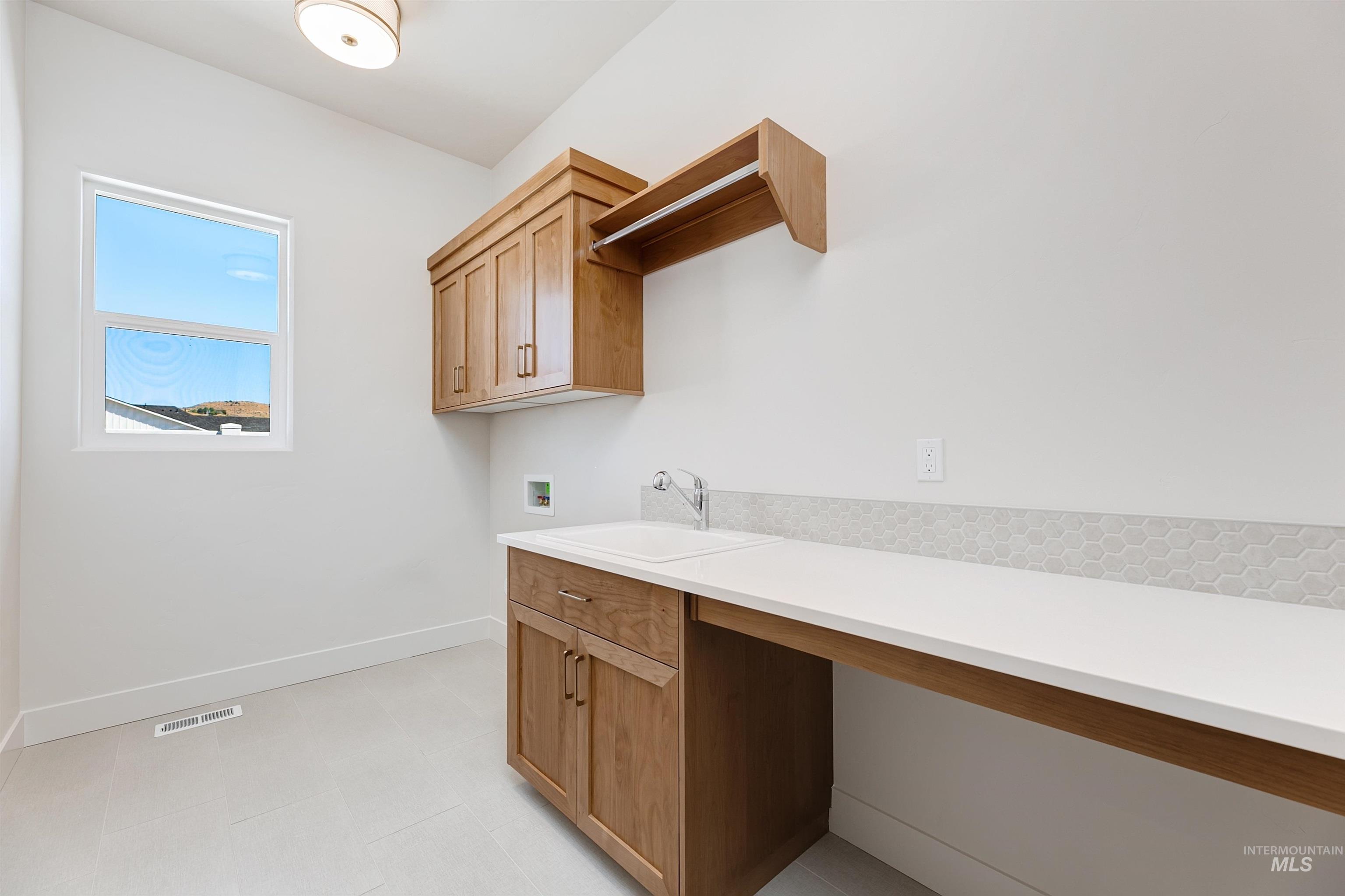 Laundry area featuring hookup for a washing machine and cabinet space