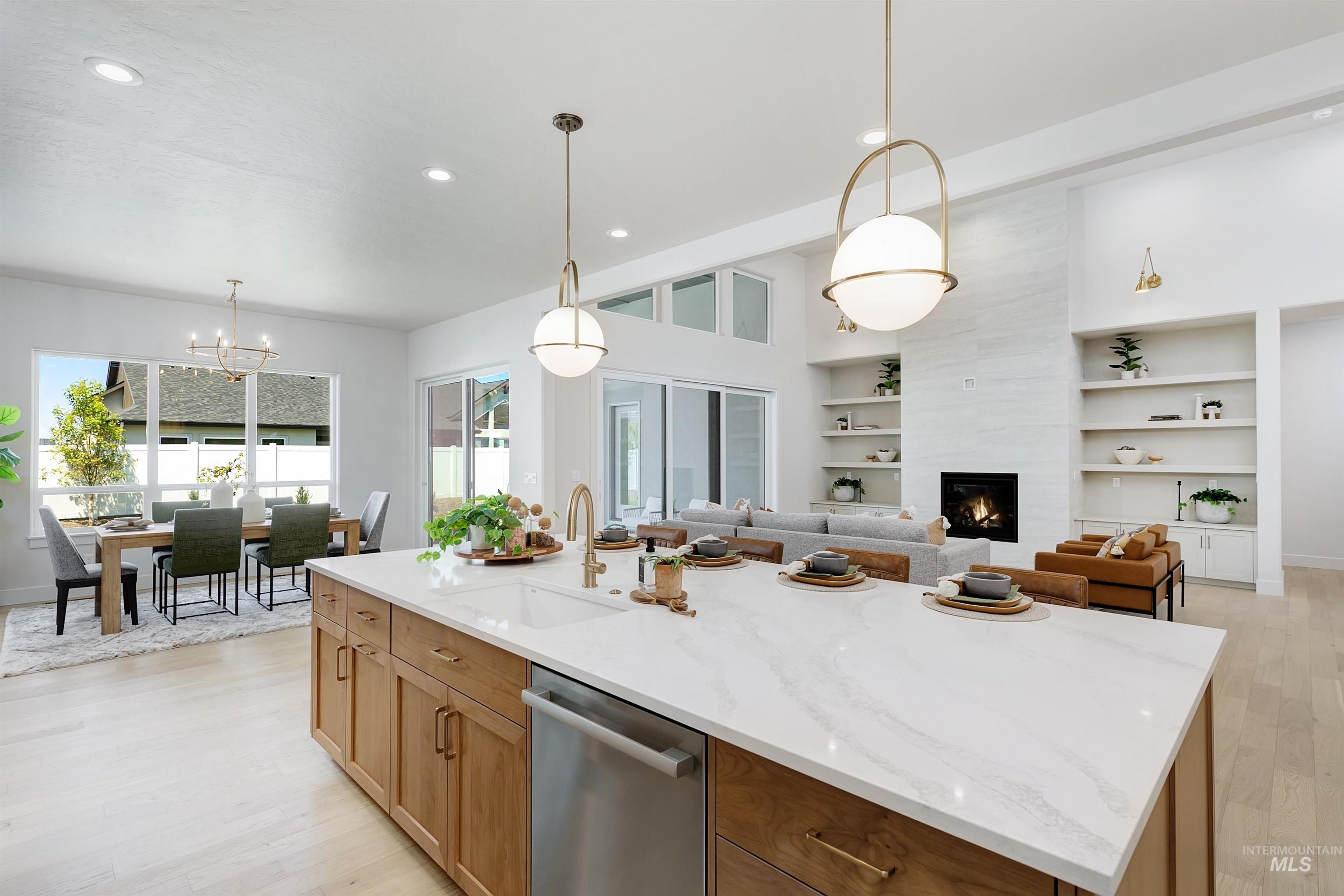 Kitchen featuring stainless steel dishwasher, light wood-type flooring, a center island with sink, recessed lighting, and light stone counters