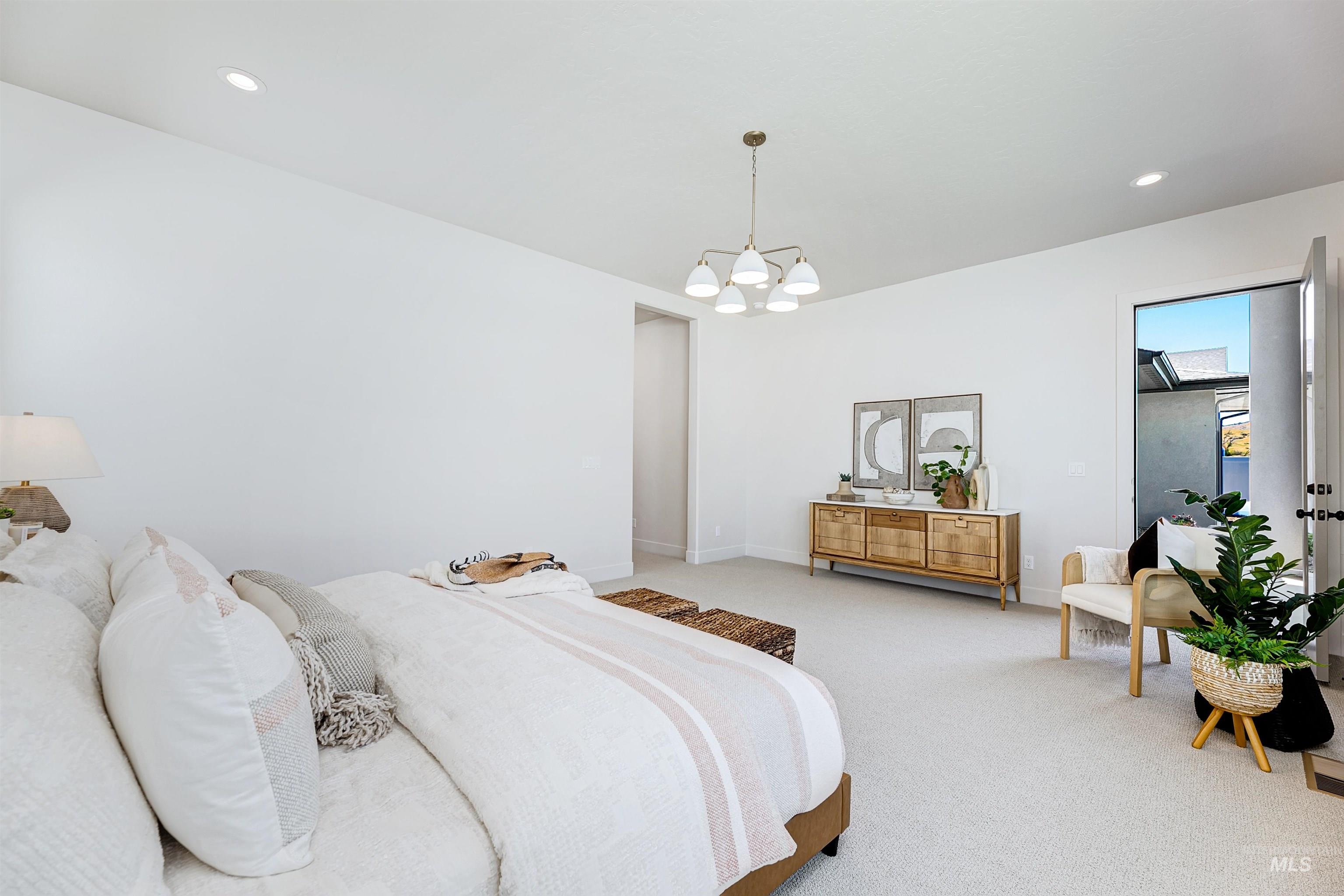 Bedroom featuring a chandelier, light colored carpet, and recessed lighting