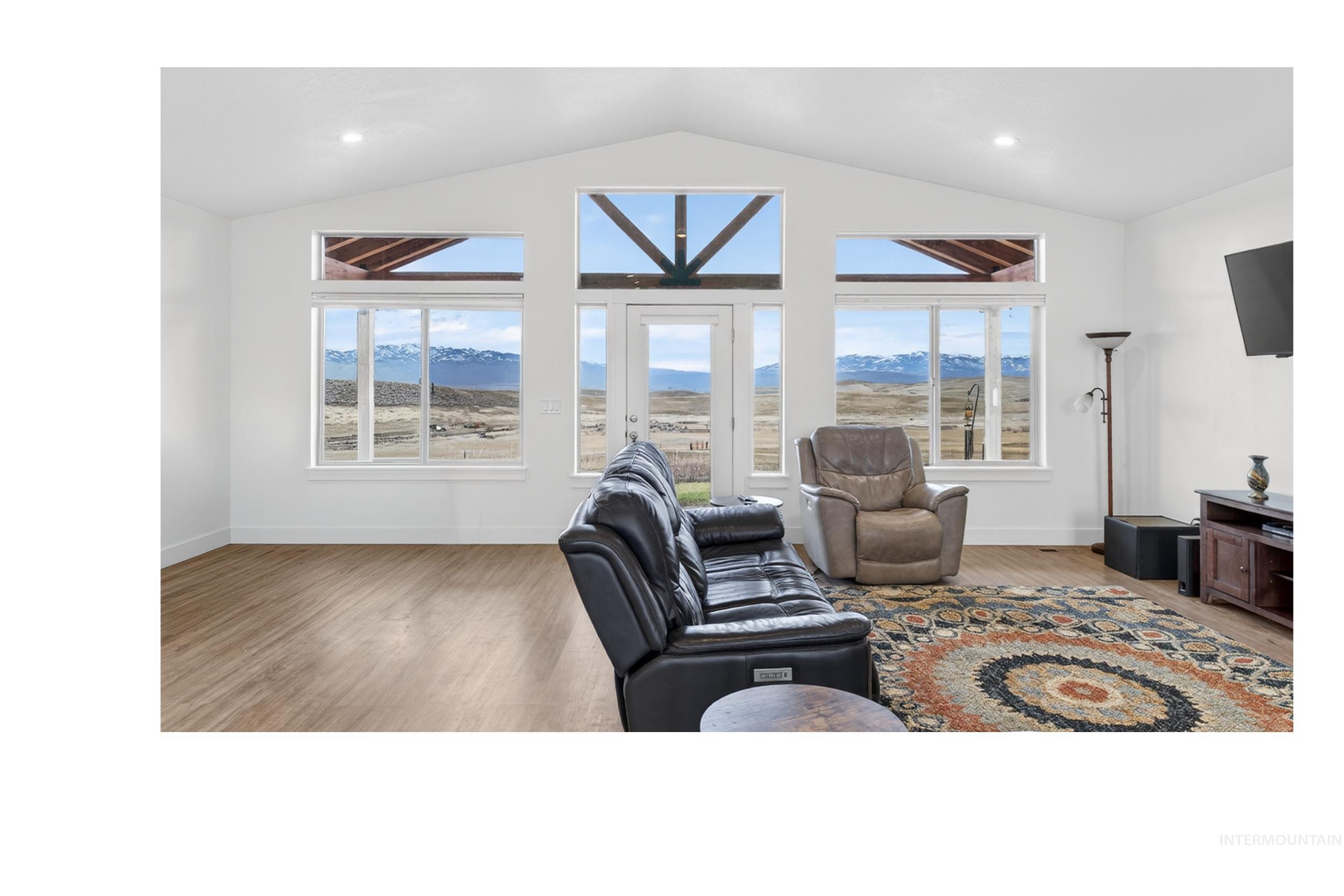 Living area with light wood-type flooring, healthy amount of natural light, and recessed lighting