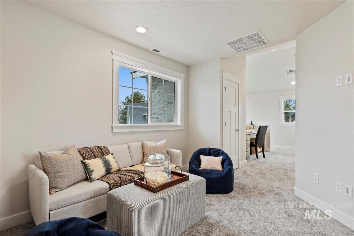 Living area with carpet, plenty of natural light, recessed lighting, and an office area