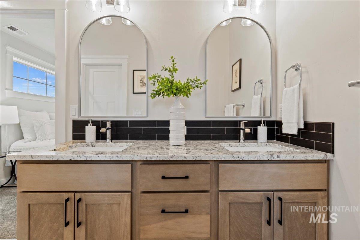 Full bath with tasteful backsplash and double vanity