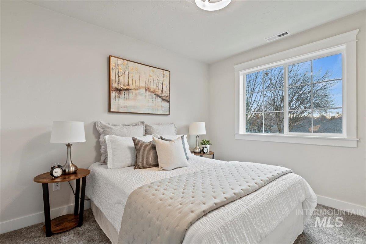 Bedroom with baseboards and carpet flooring