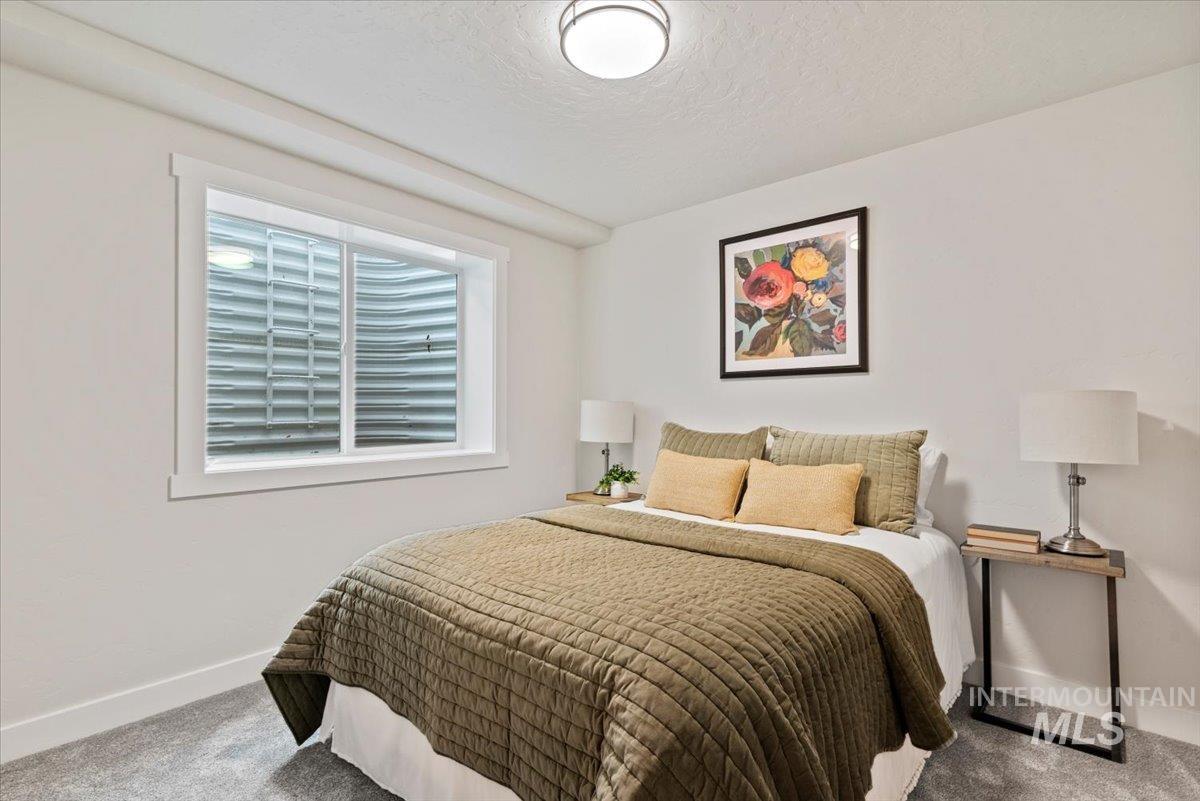 Bedroom with carpet floors and a textured ceiling