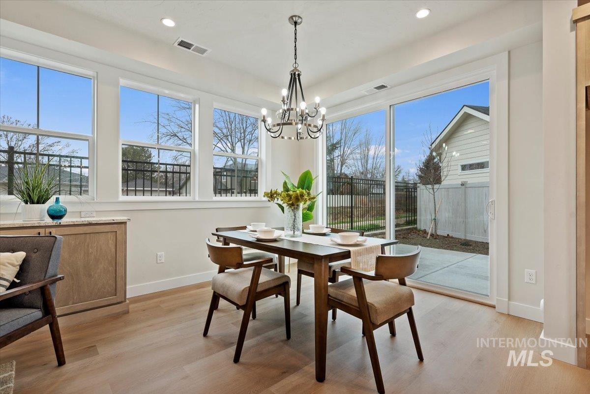 Dining room featuring light wood finished floors, a chandelier, and recessed lighting