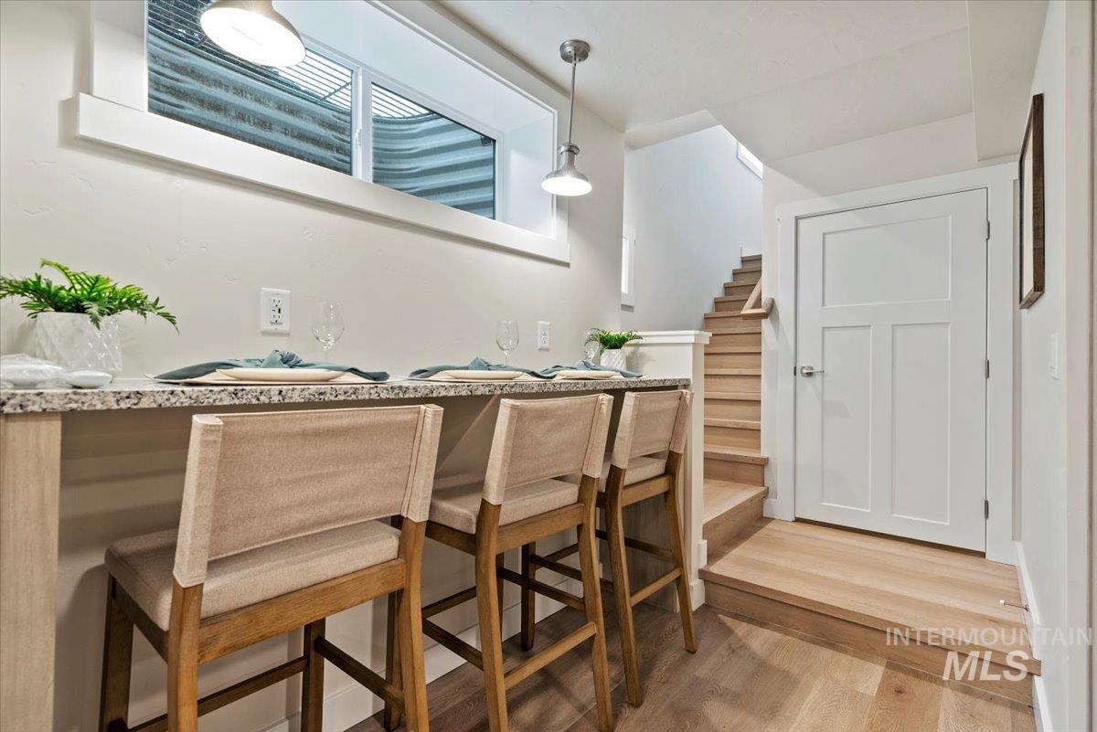 Dining area featuring light wood finished floors and stairs