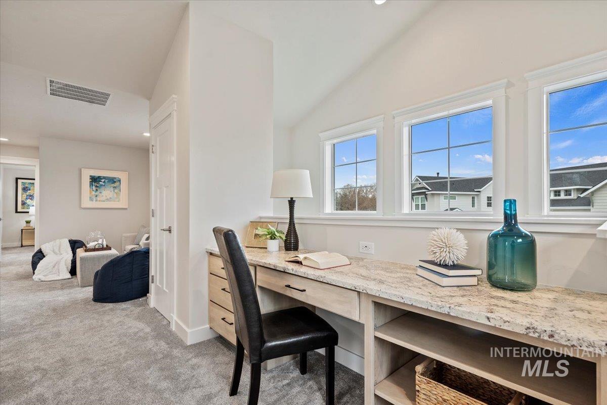 Office featuring light colored carpet, recessed lighting, and lofted ceiling