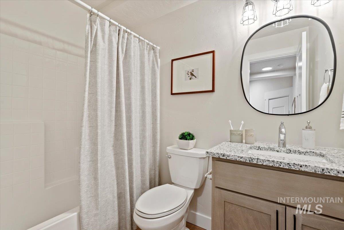 Full bathroom with vanity and shower / bath combination with curtain