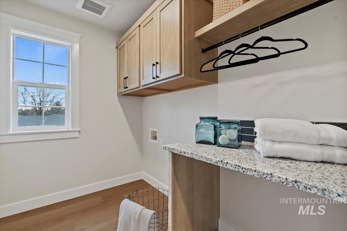 Laundry room featuring light wood-style floors and washer hookup