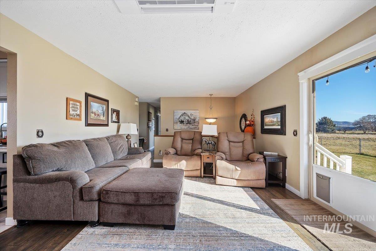 Living area featuring wood finished floors and a textured ceiling