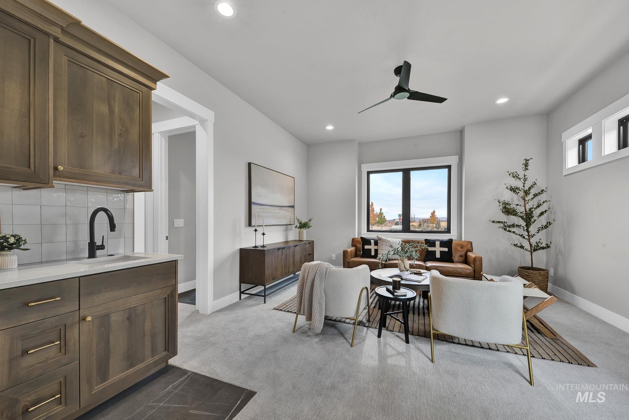 Living area featuring recessed lighting, ceiling fan, and dark colored carpet