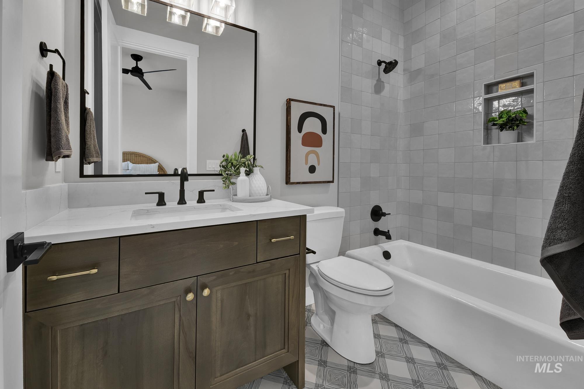 Bathroom with bathing tub / shower combination, vanity, a ceiling fan, and ensuite bath