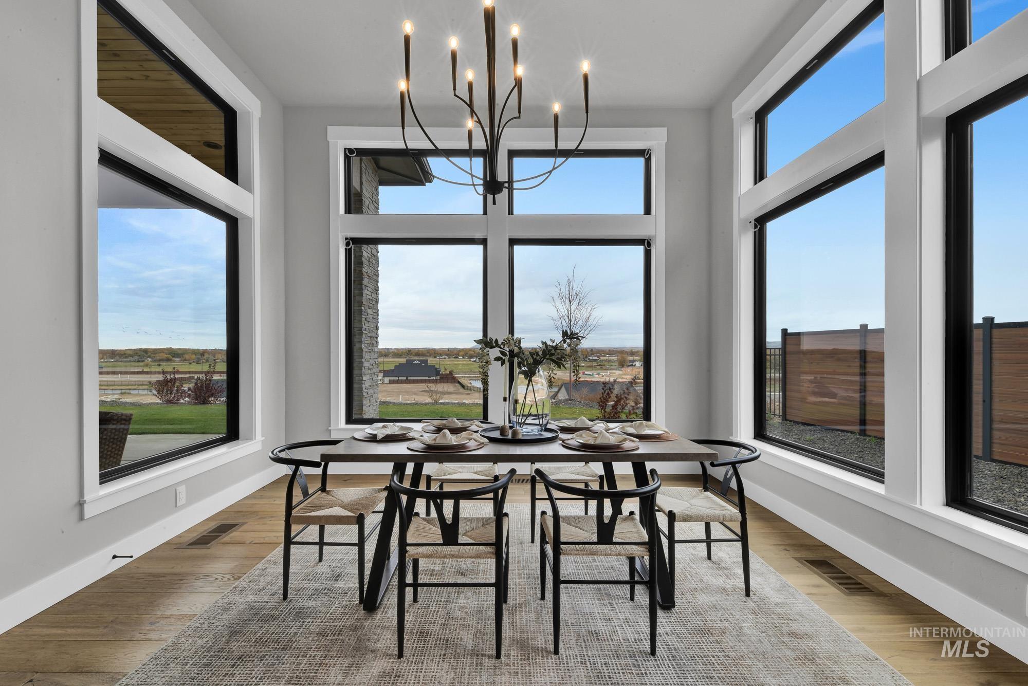 Dining area featuring wood finished floors and a chandelier