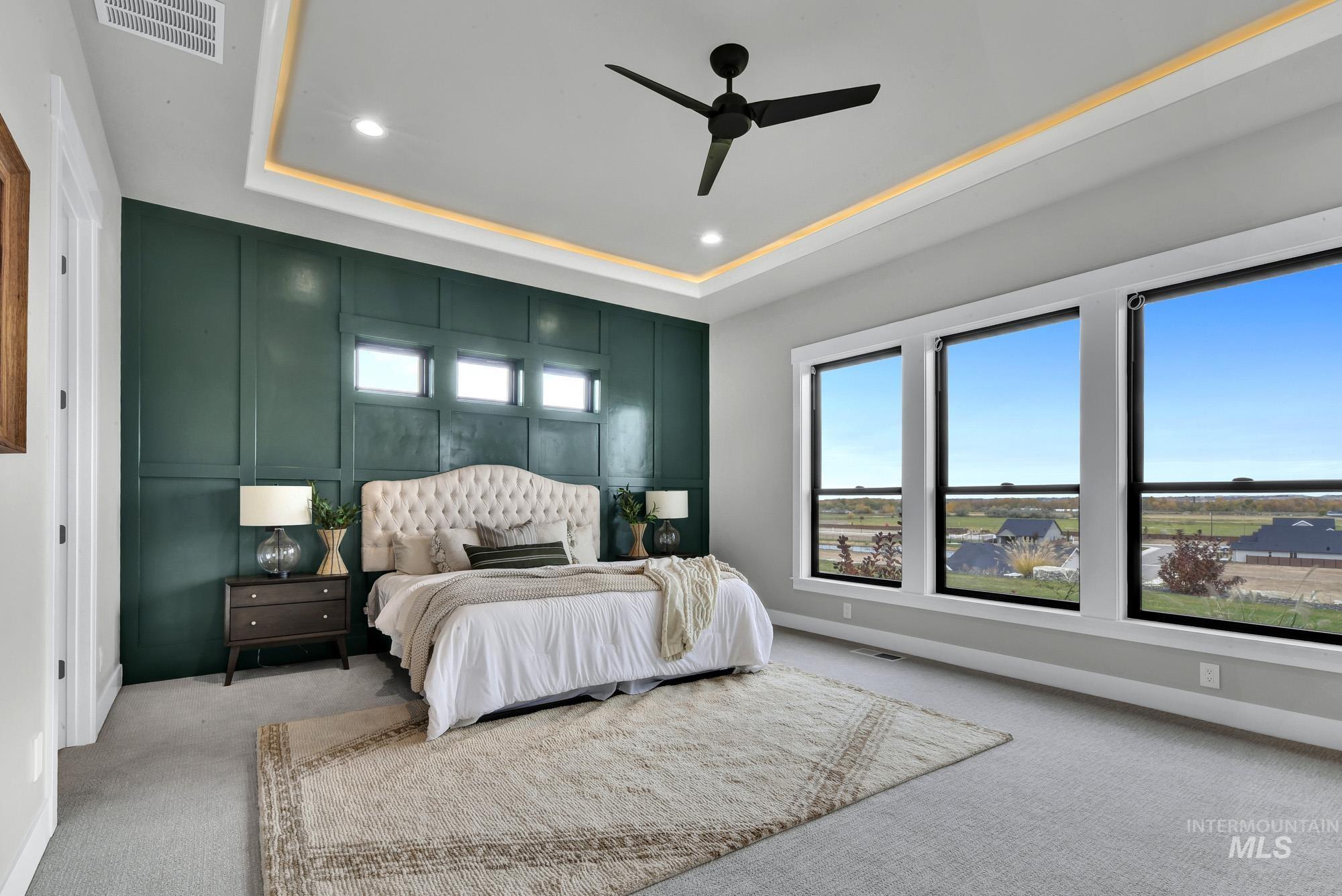 Bedroom featuring a tray ceiling, carpet, ceiling fan, and recessed lighting
