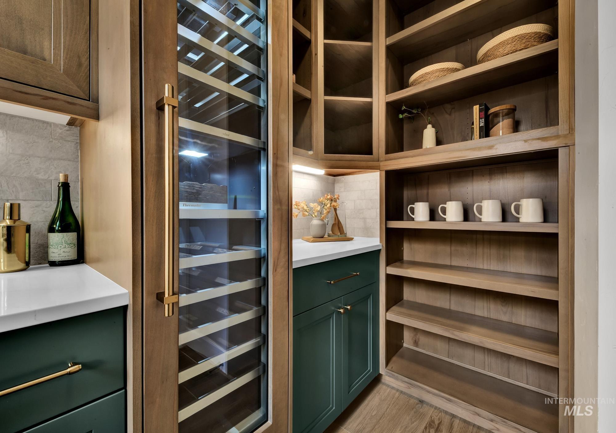 Wine room featuring wine cooler and light wood finished floors