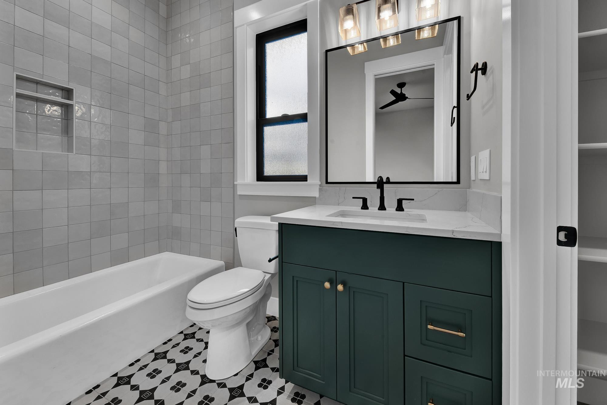 Bathroom featuring tub / shower combination and vanity