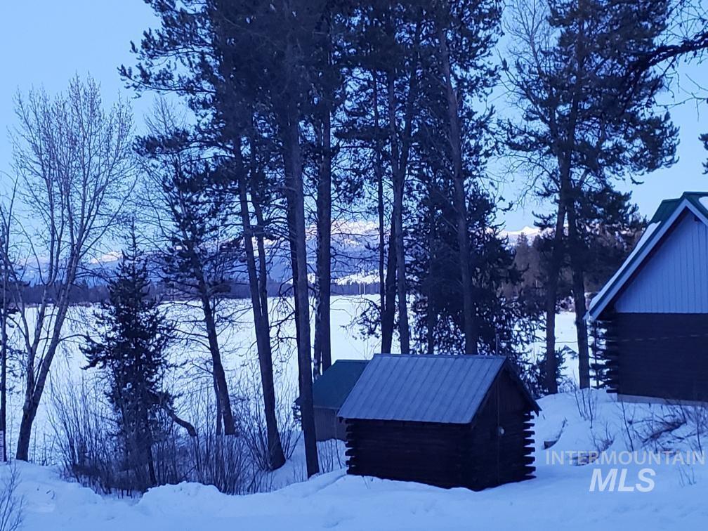View of snow covered exterior featuring log siding
