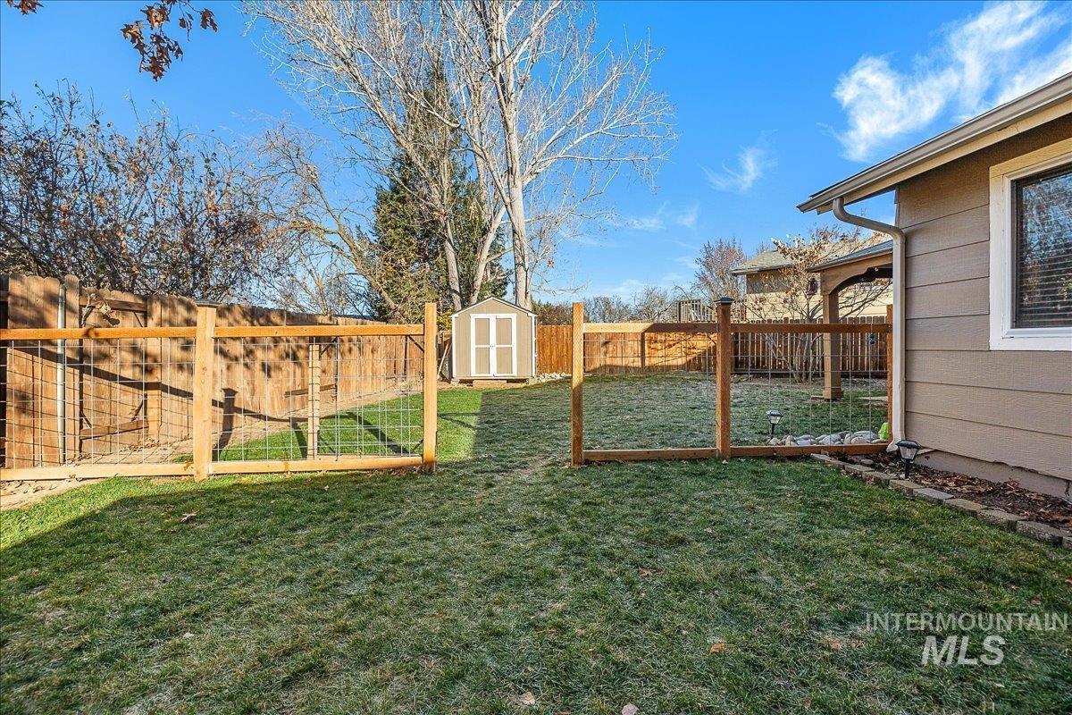 Fenced backyard with a storage unit
